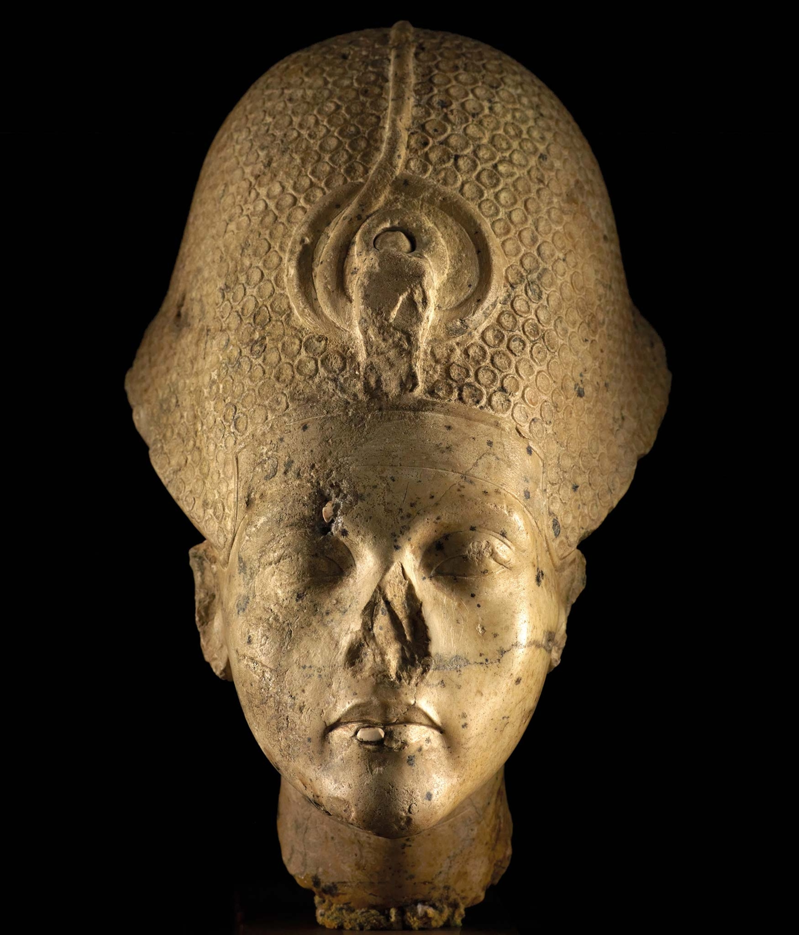 A bust of King Tut wearing a crown
