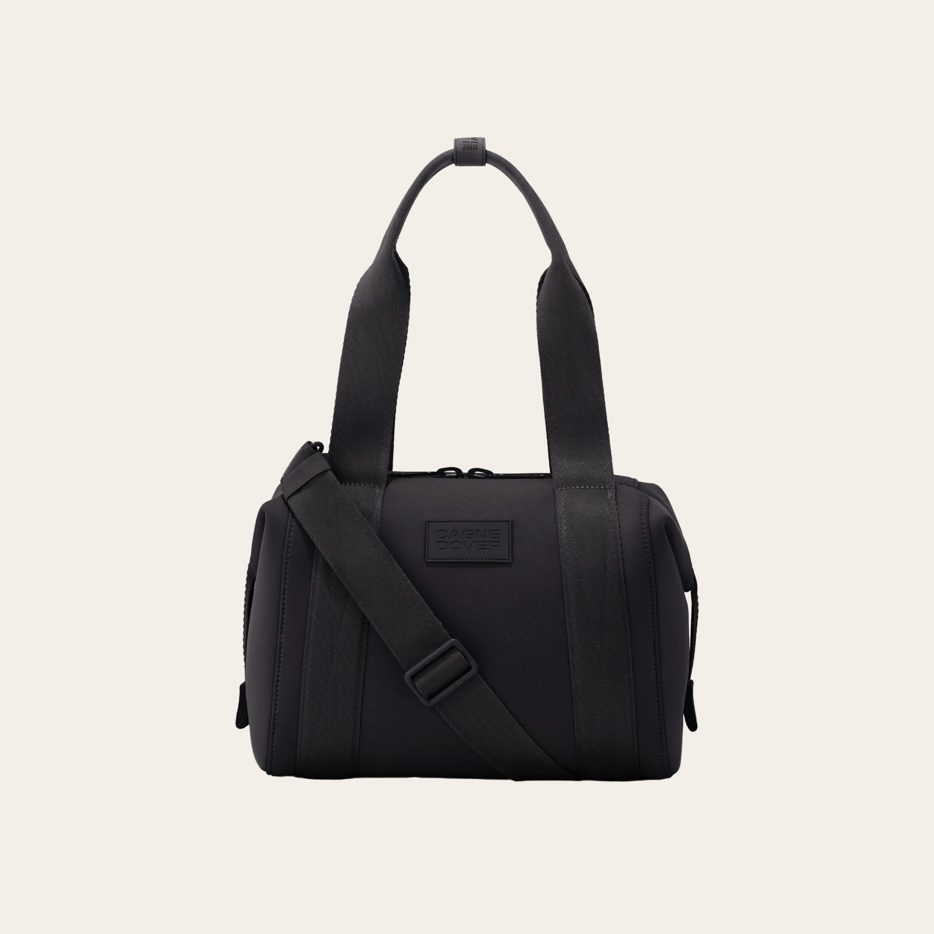 A black tote bag against a tan background
