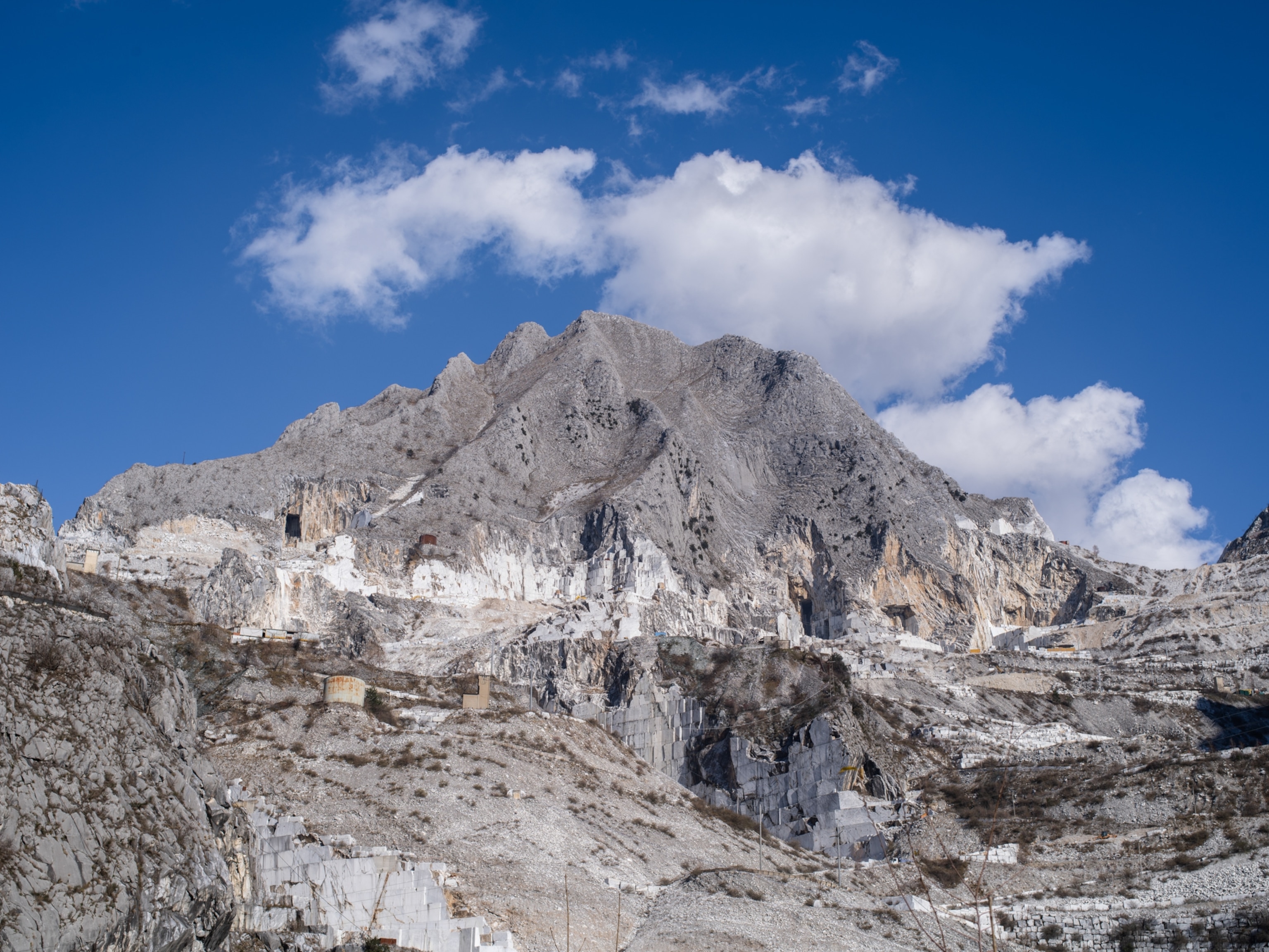 A mountain, partially carved up by the mining process to remove veins of marble.
