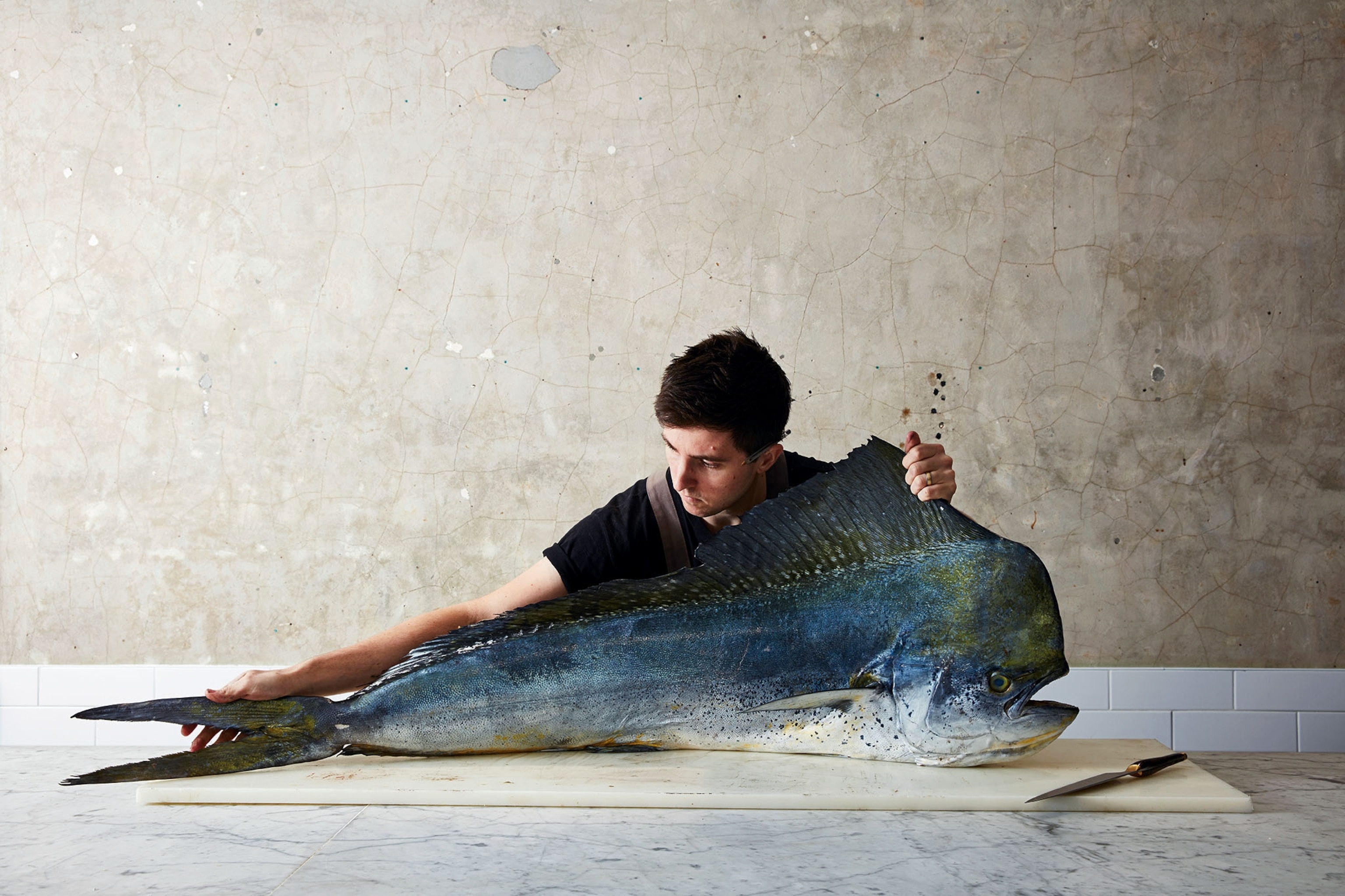 a man preparing a large fish