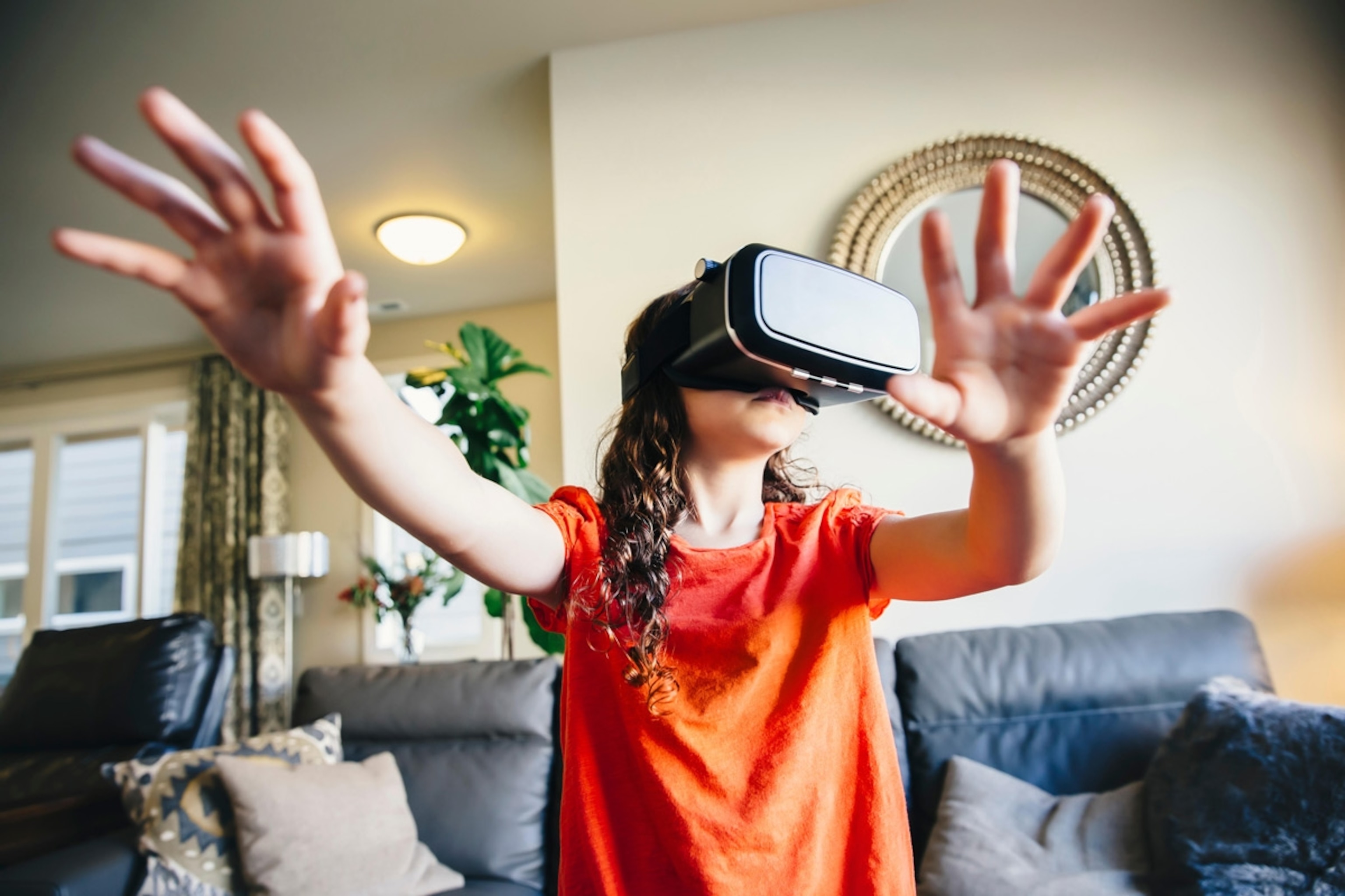 Mixed race girl using virtual reality goggles. Seattle, WA