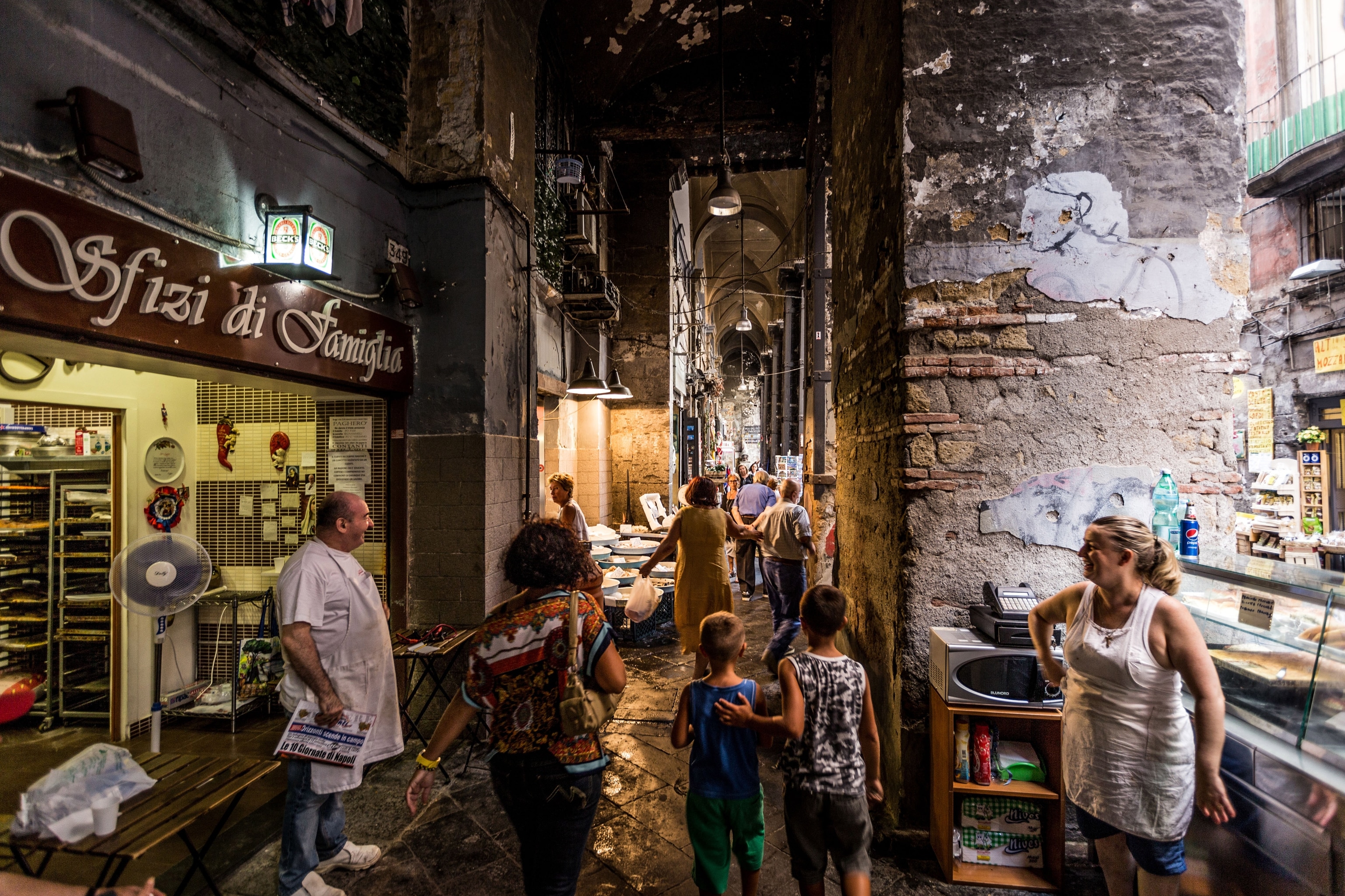 A busy historic street in Naples in the evening