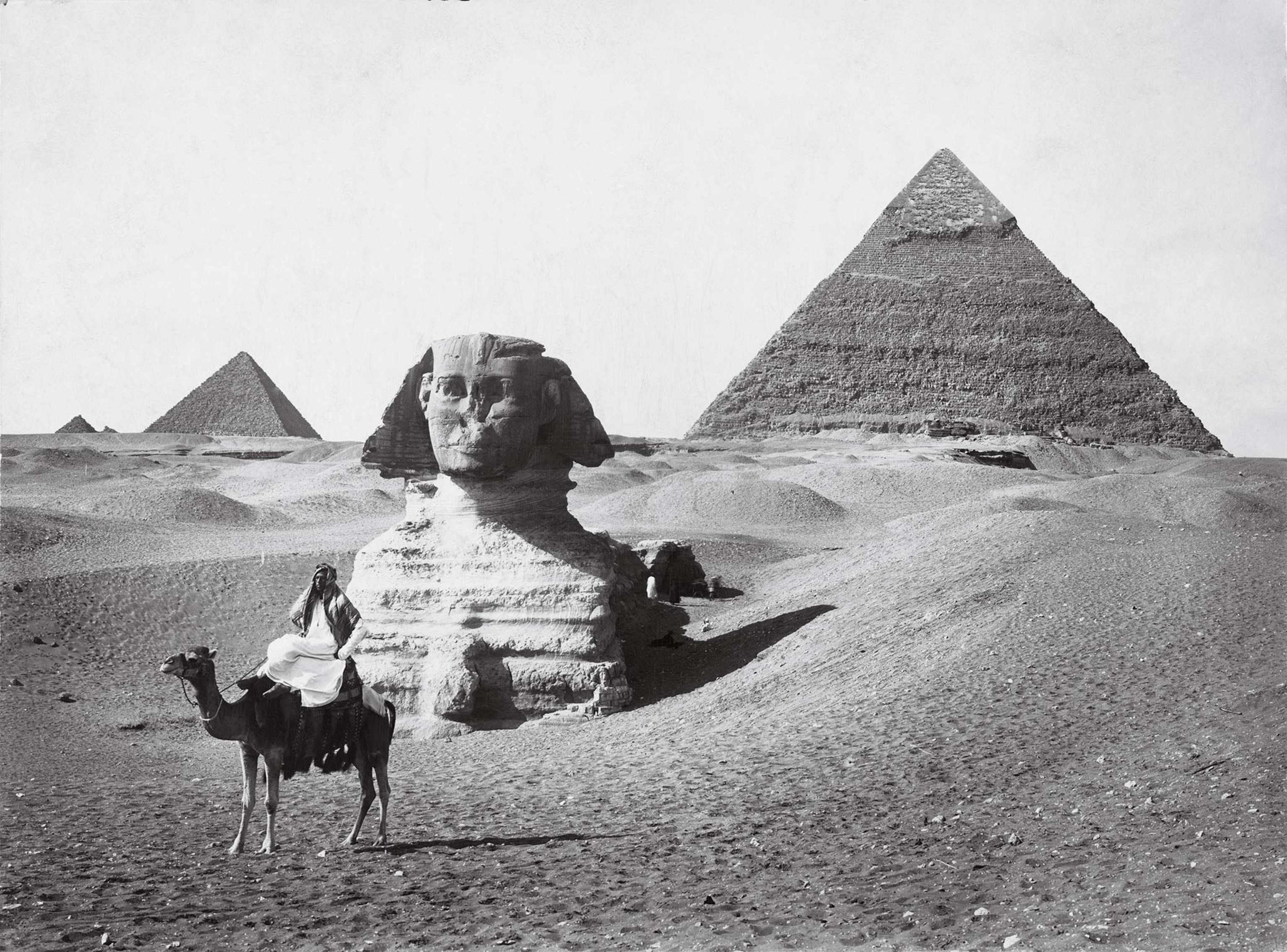 Photographed for the September 1913 issue of National Geographic, an unidentified rider takes a moment of rest before the Sphinx and the pyramids of Giza.
