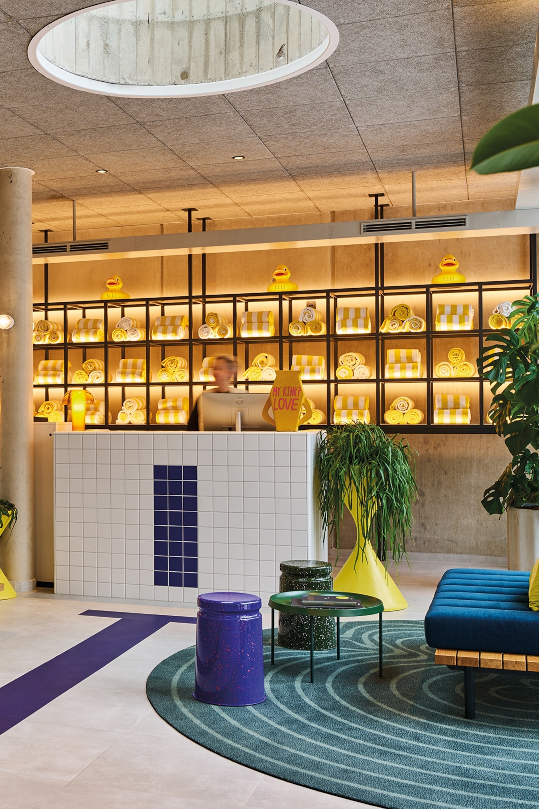 Hotel lobby with tiles, rubber duck decorations and yellow accents