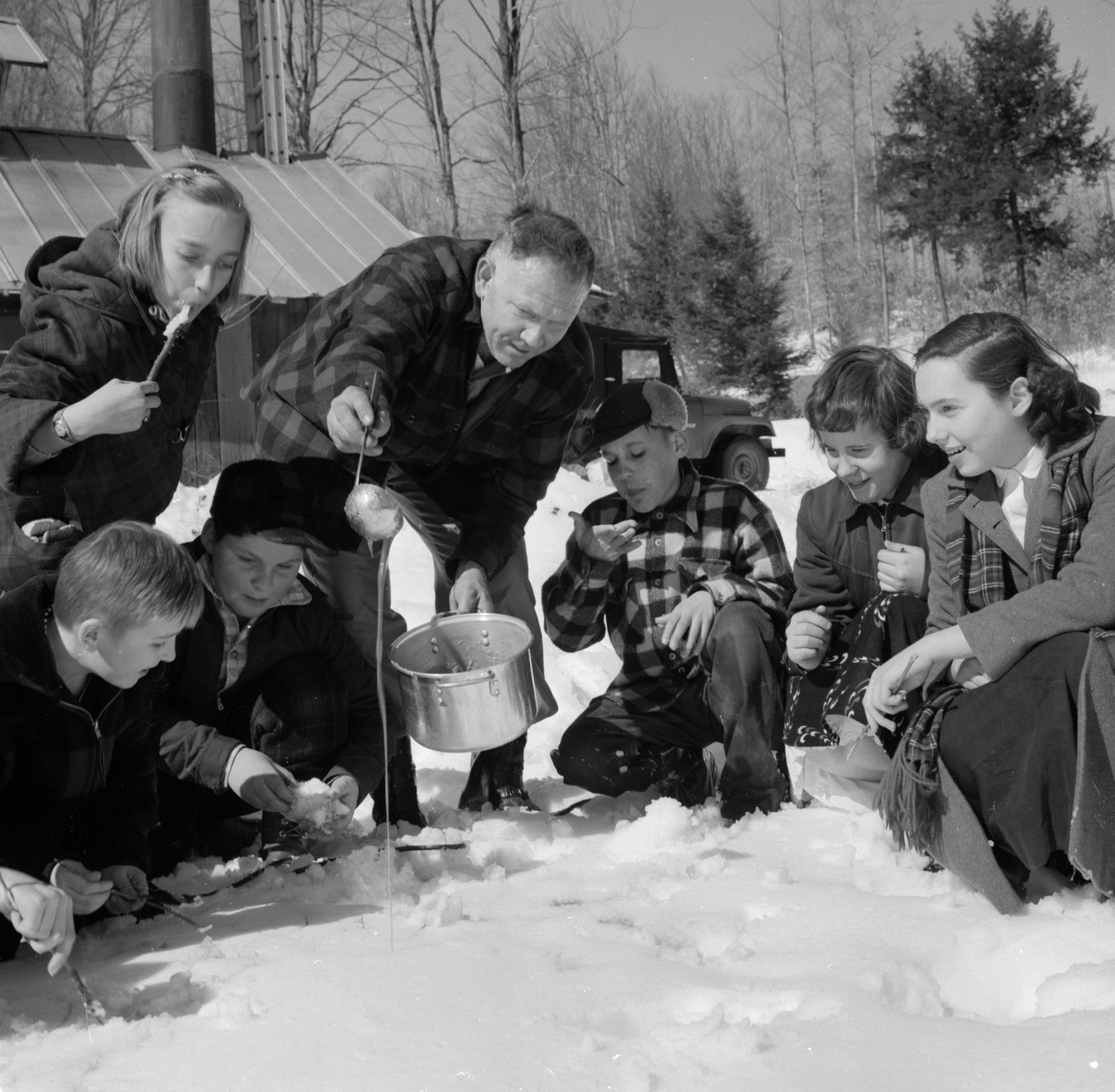 American farmer Harold Eastman of the Quechee Fells farm at Quechee, Vermont, pours hot maple syrup from his orchard onto cold snow for the New England treat of sugar-on-snow.