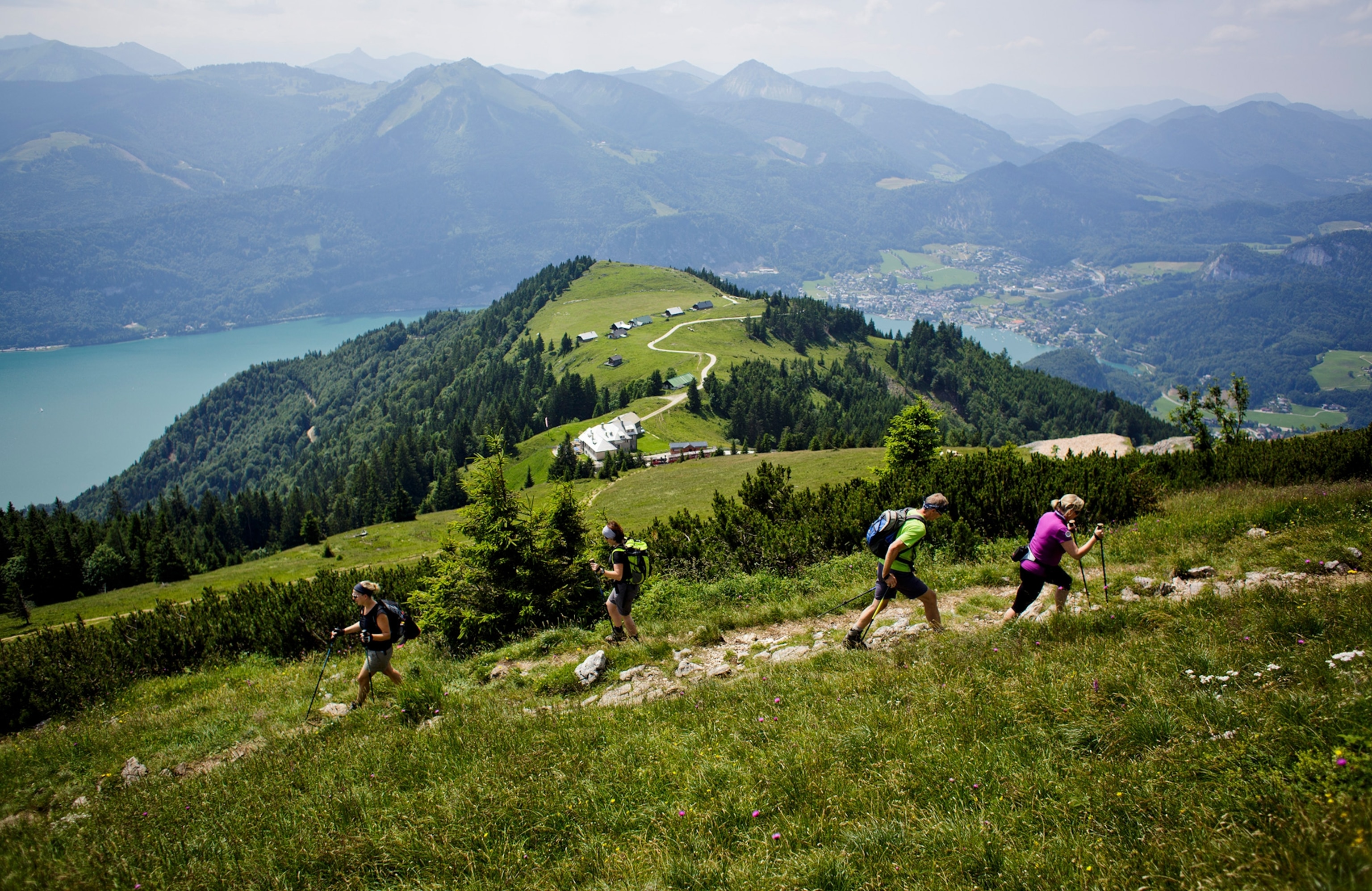 Hikers walk on Schafberg mountain.