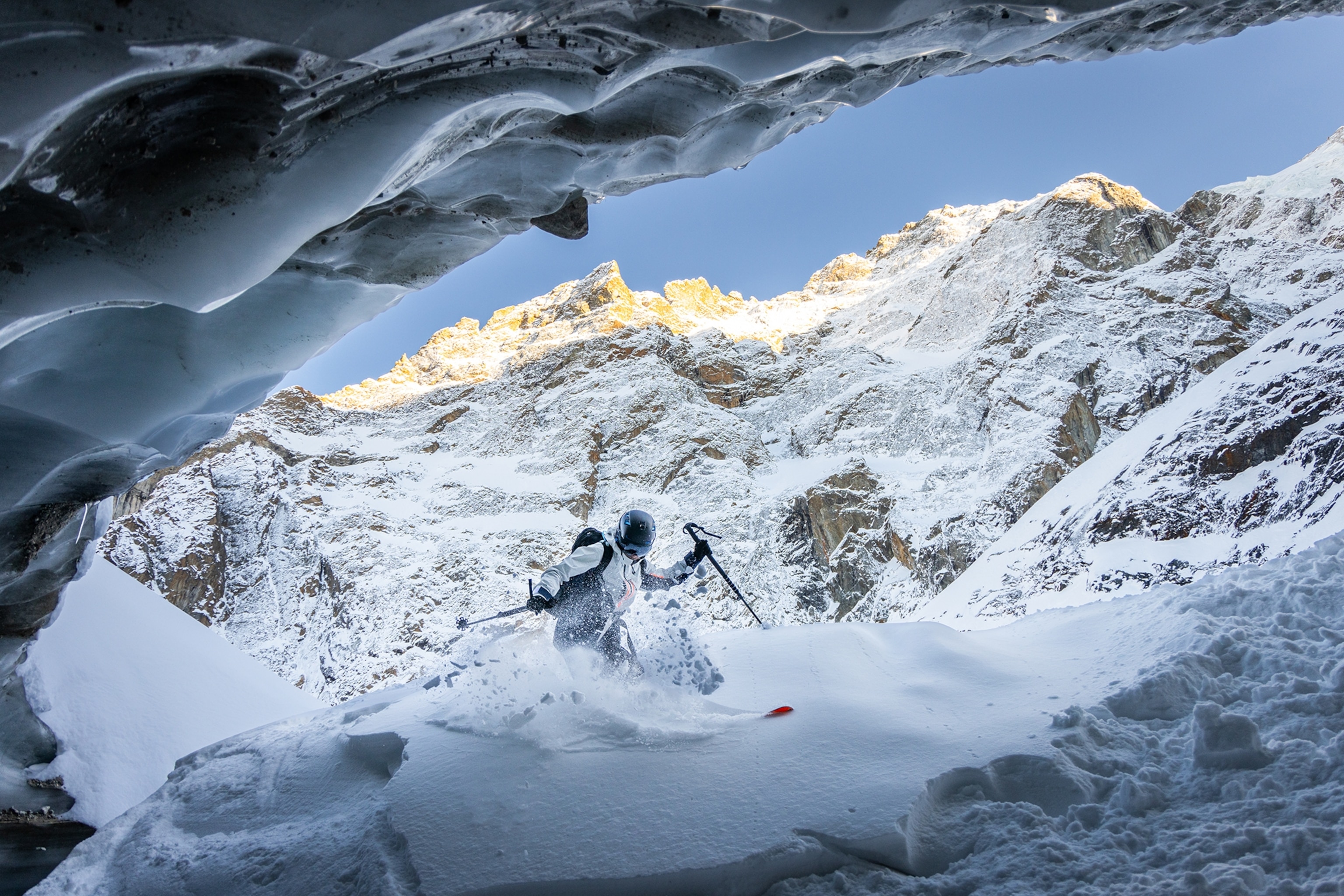 A skiier skis past a cave at La Grave ski resort in the French Alps, France.