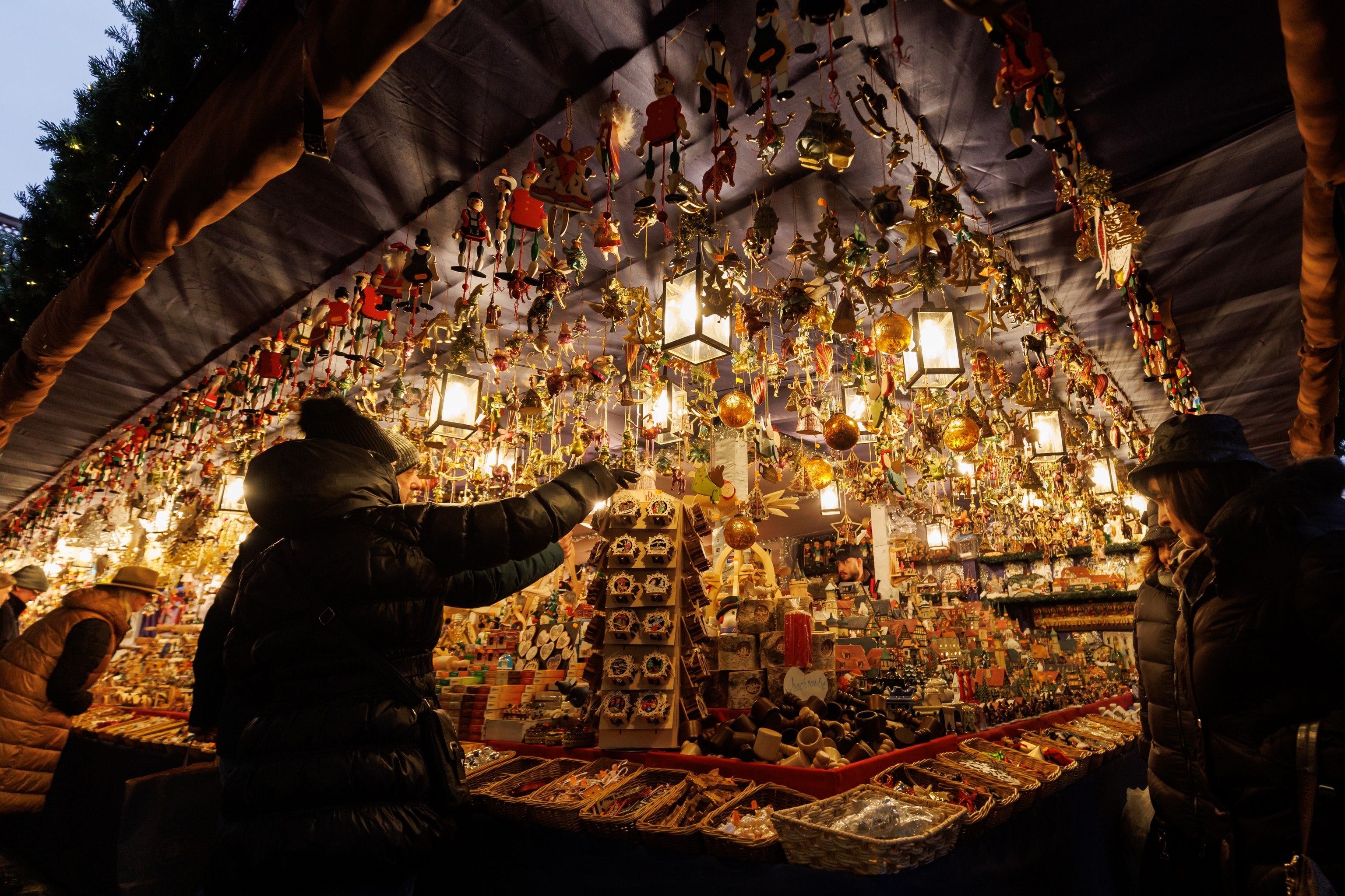 A person reaches for christmas decorations displayed for sale at Nuremberg's Christkindlesmarkt.