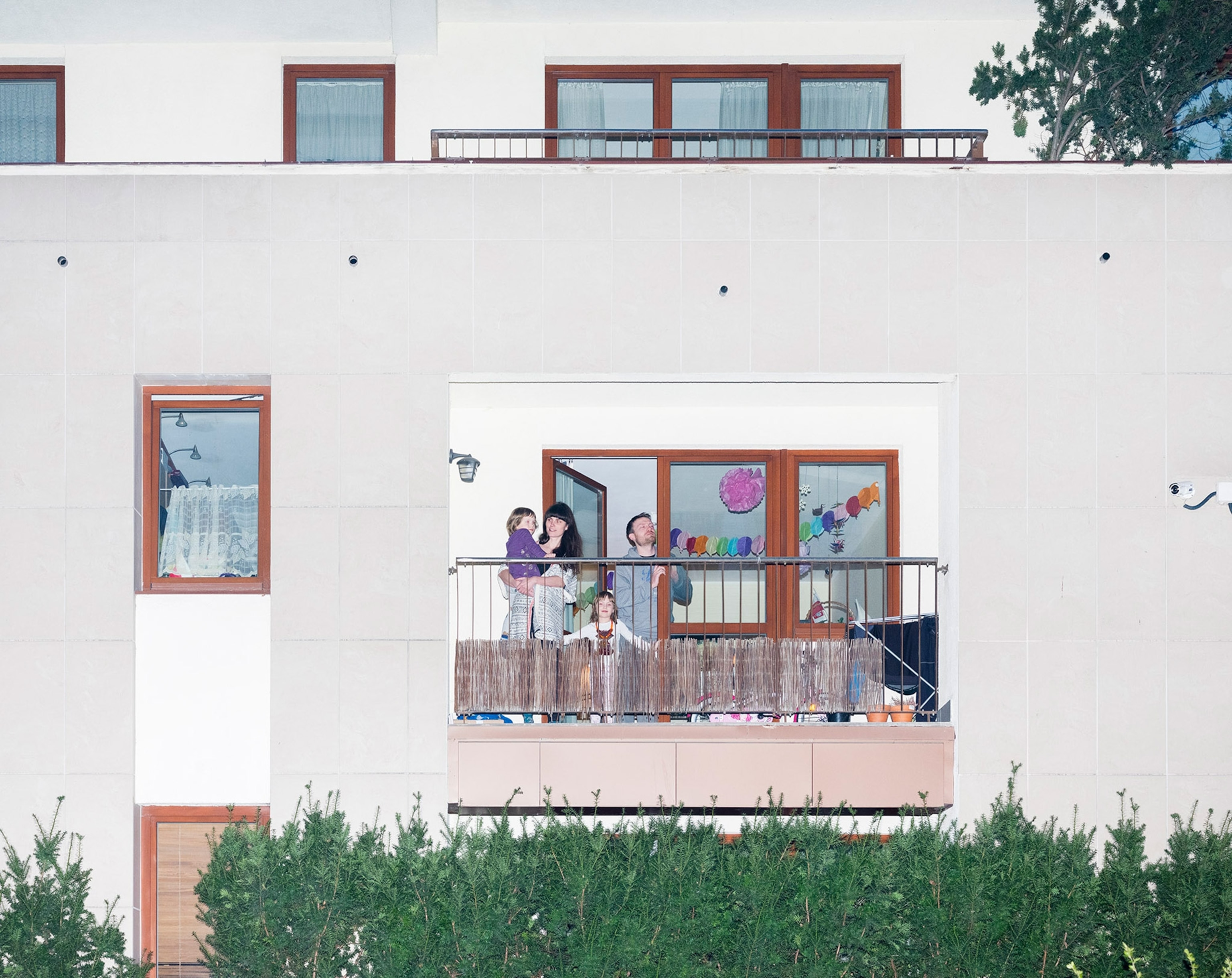 a family celebrating a birthday on their balcony