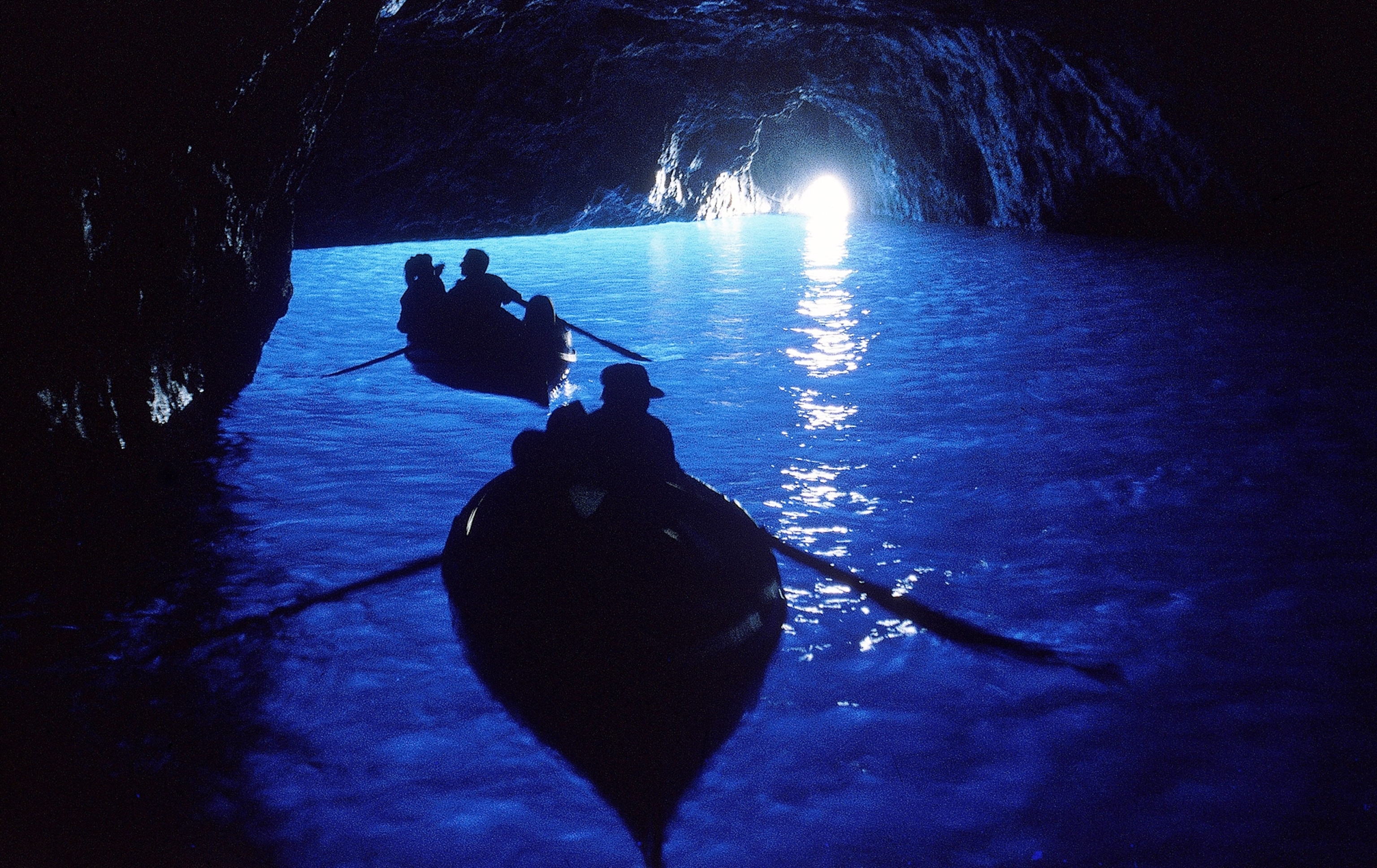 Two boats move through the Blue Grotto cave.