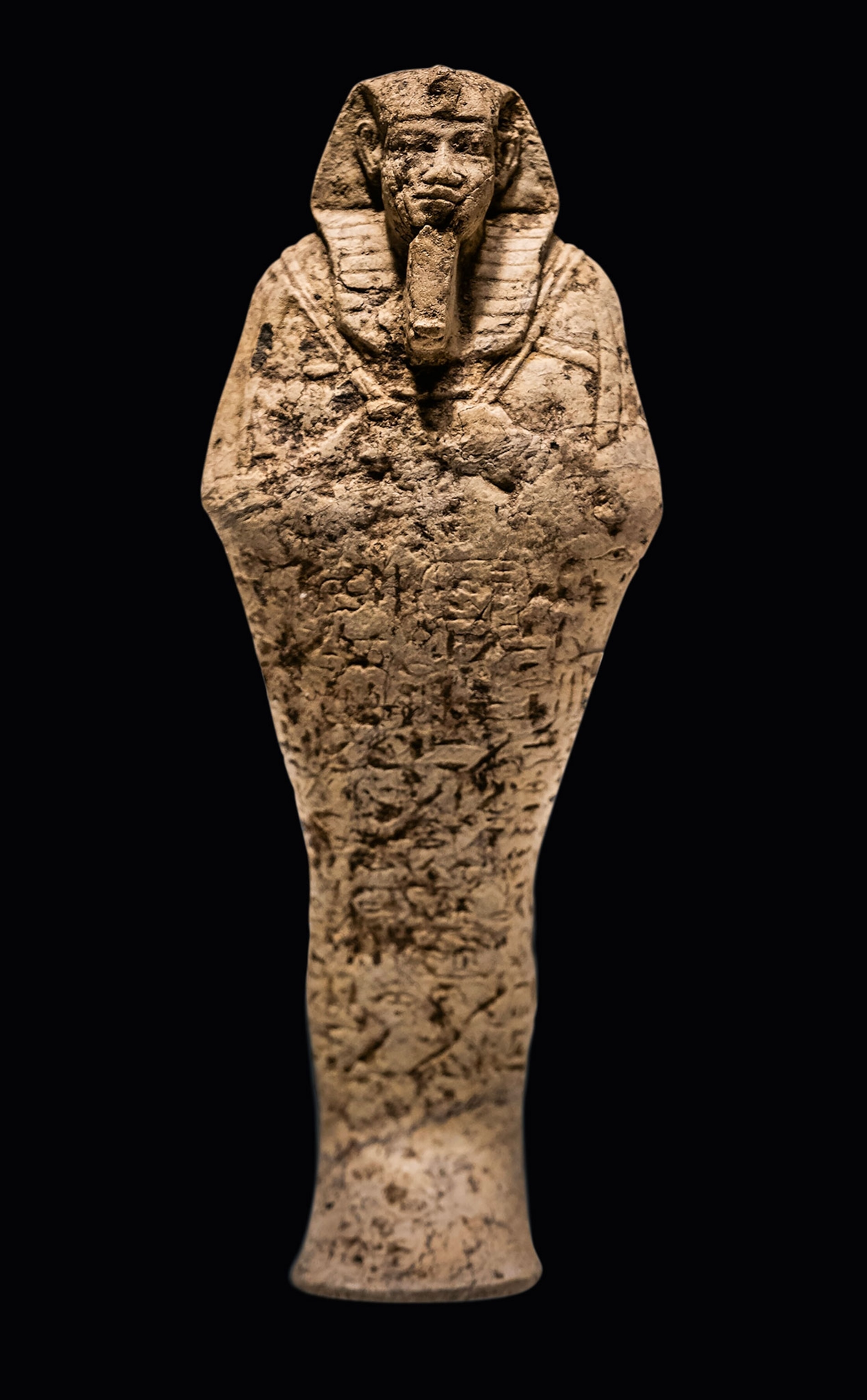 An age-worn statue of an Egyptian pharaoh