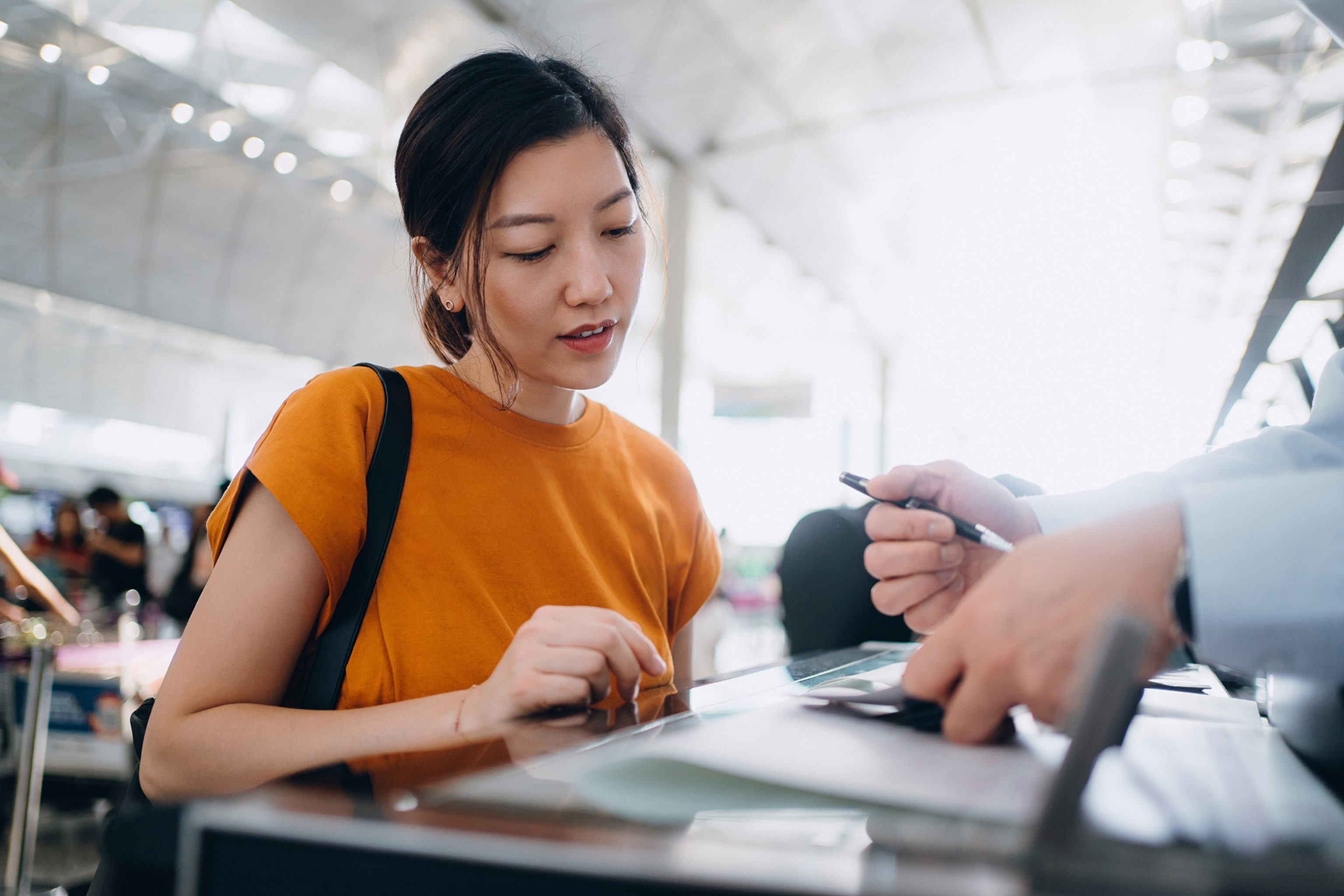 Traveller signing documents in an airport