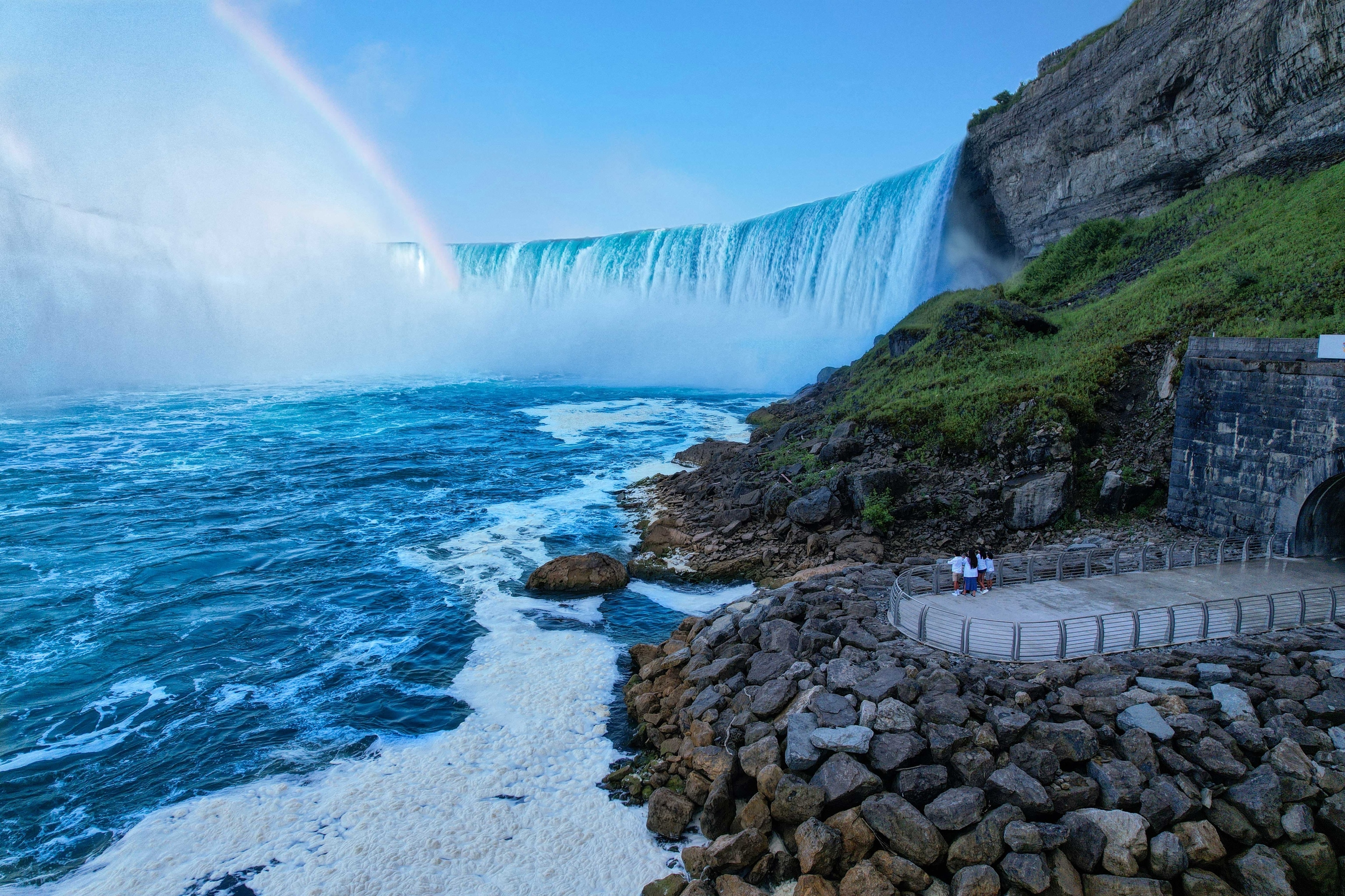 Niagara Falls in the background with a viewing platform in the foreground.