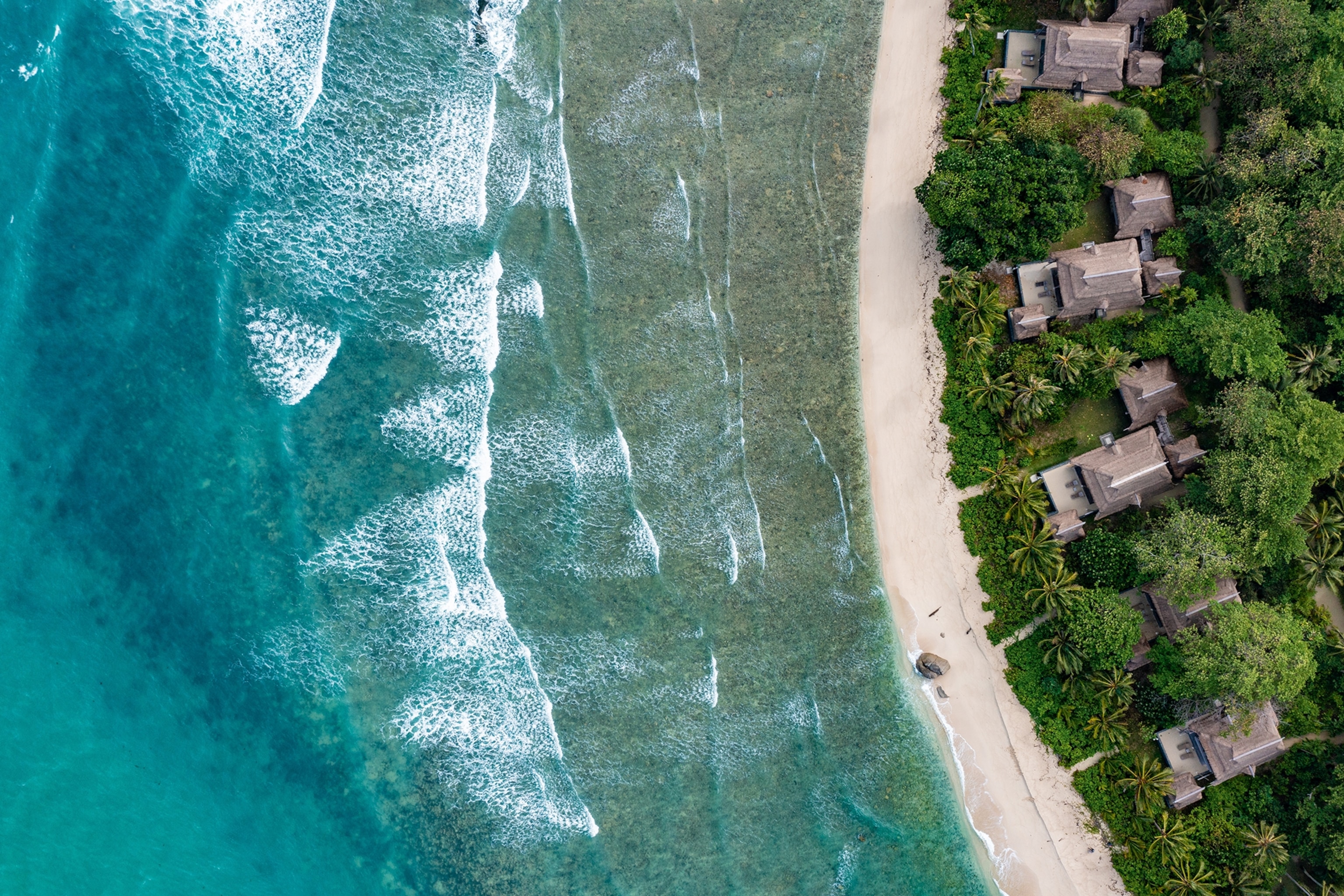 Arial view of Nikoi Island, Indonesia, bordering the sea.