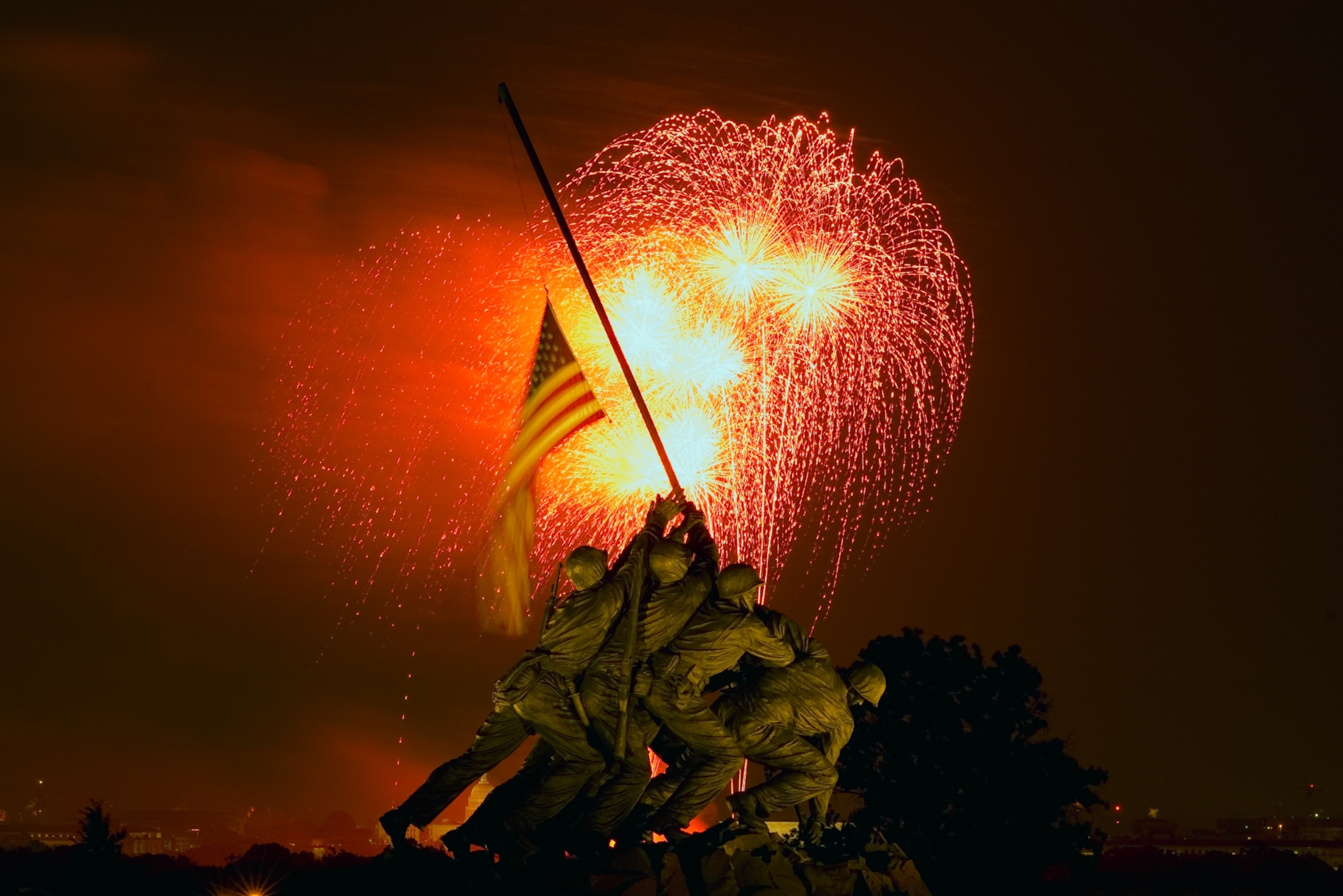 Independence Day fireworks illuminate the Iwo Jima Memorial.