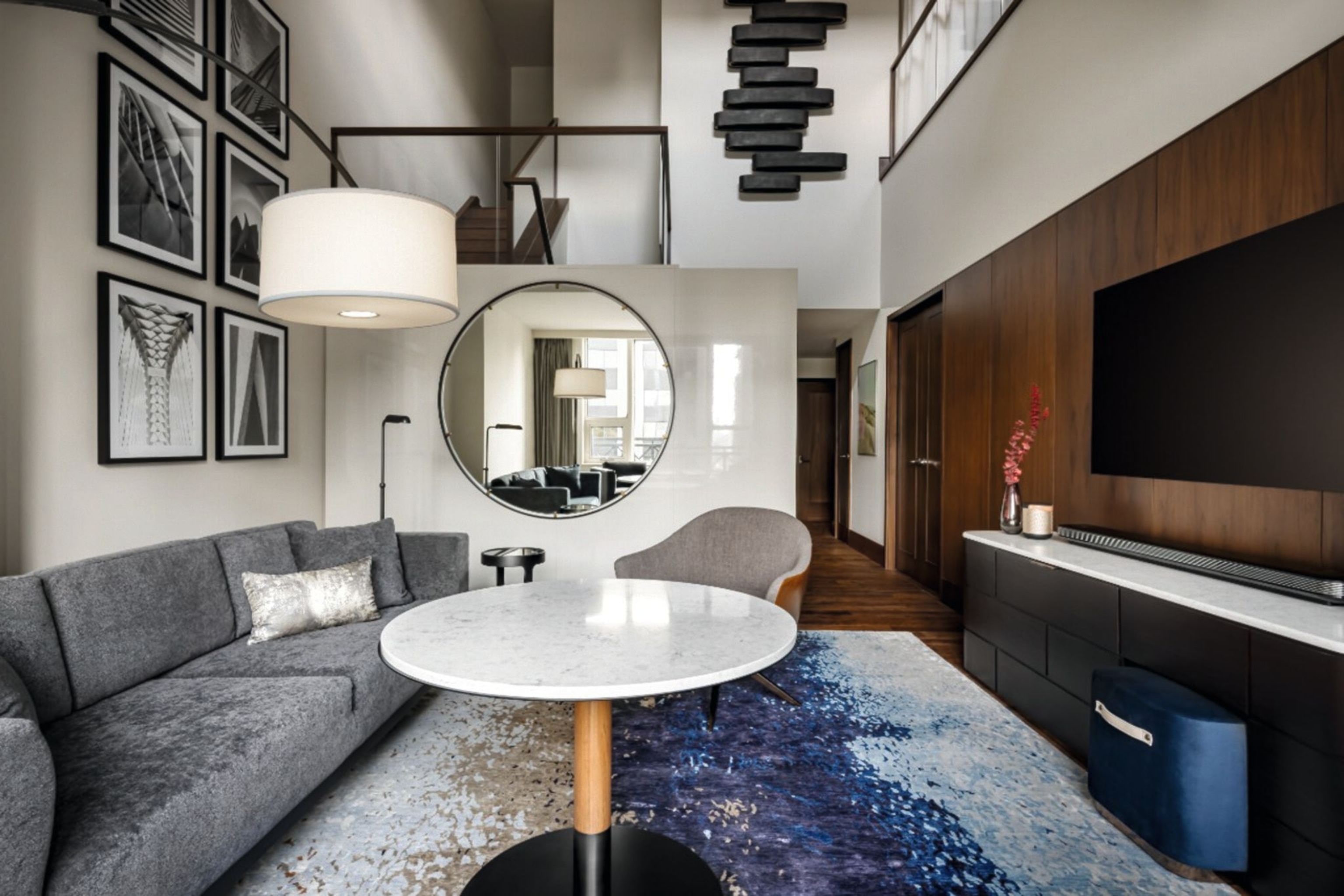 Bi-Level Suite at Park Hyatt Toronto. It has a large TV and sofa.