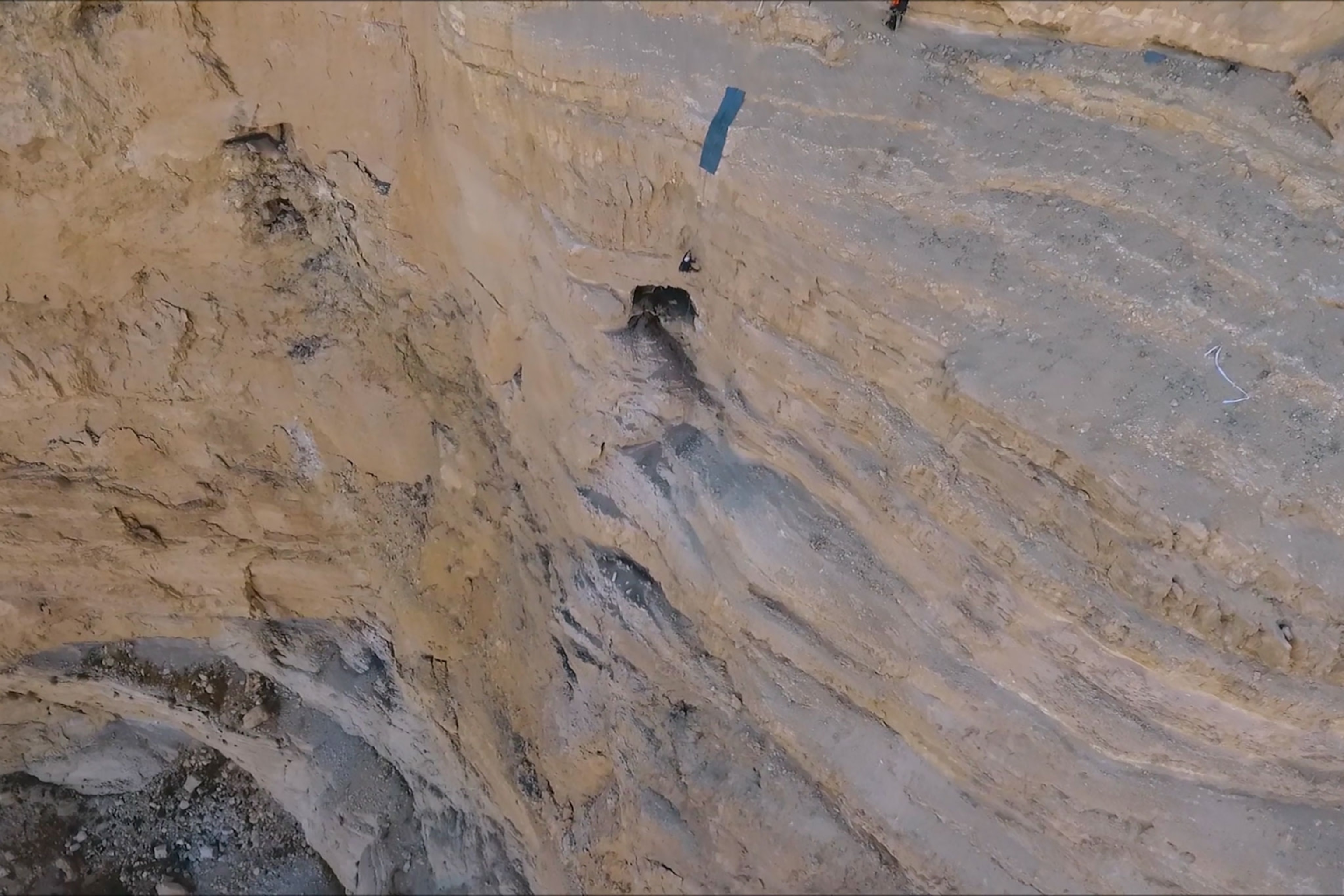 a person rappelling into a cave