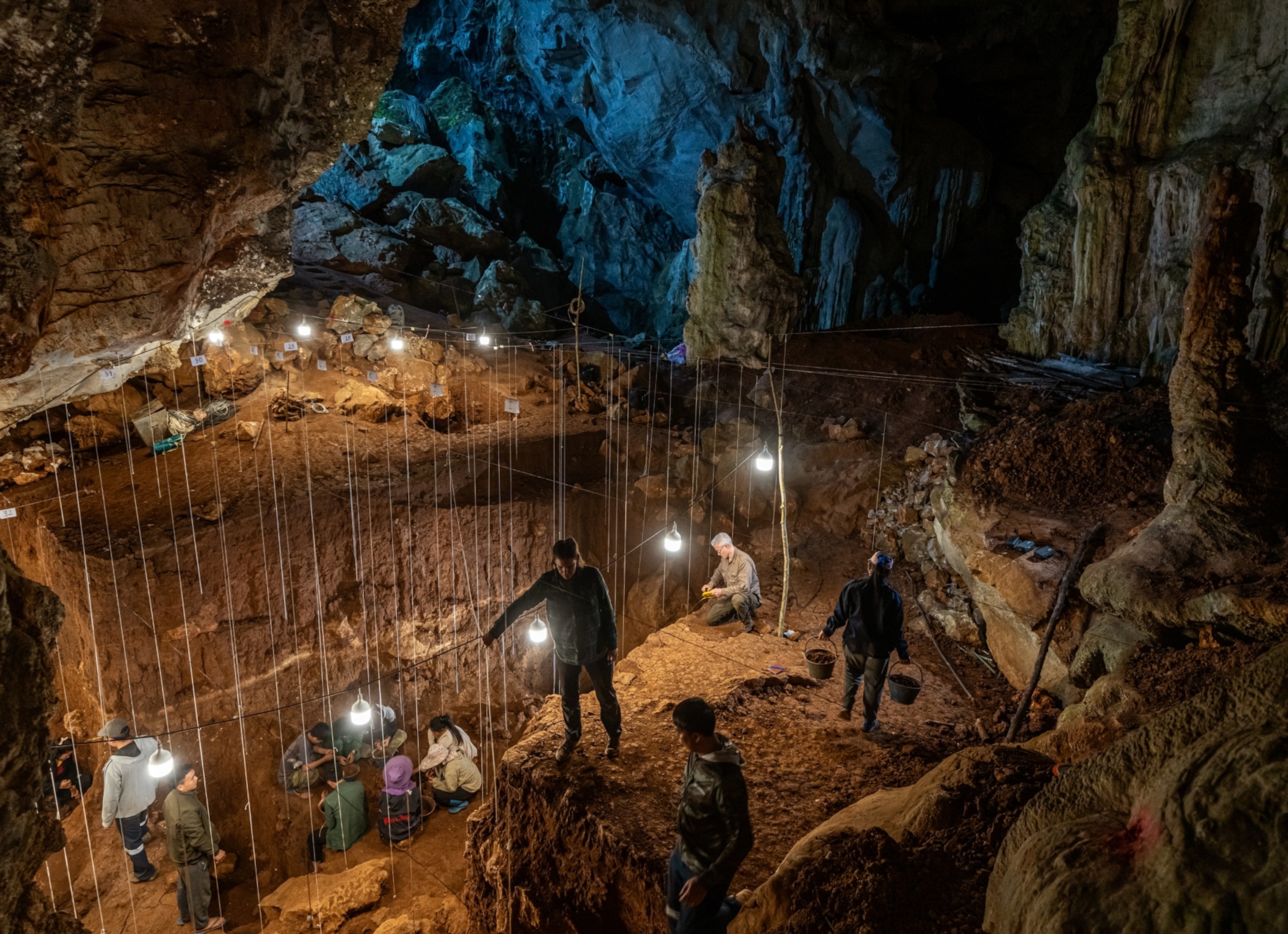 A team of people working inside of a cave.