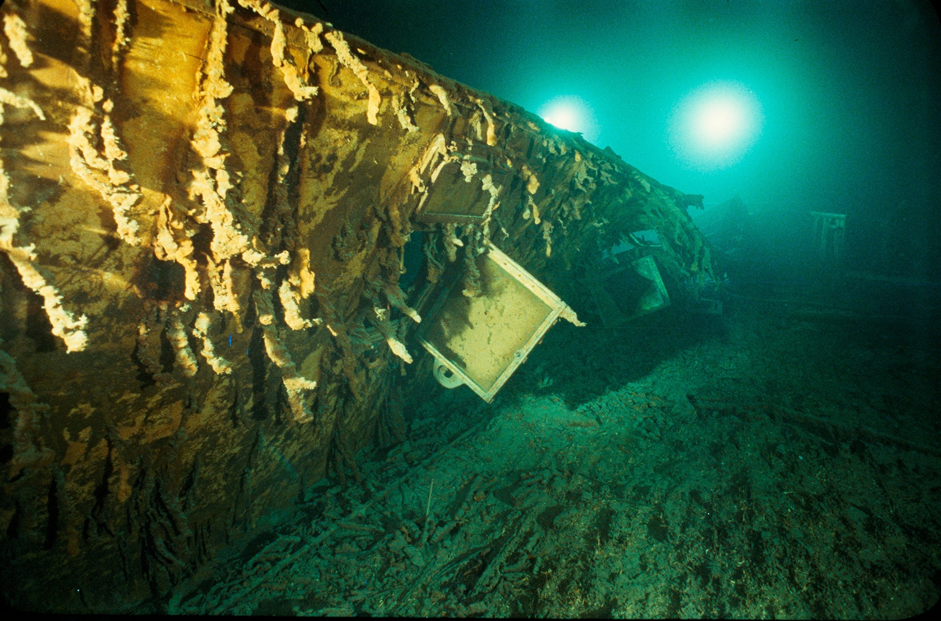 An intact glass pane from the window of Captain Edward J. Smith's cabin hangs open on the Titanic, which lies two and a half miles (four kilometers) beneath the North Atlantic Ocean.
