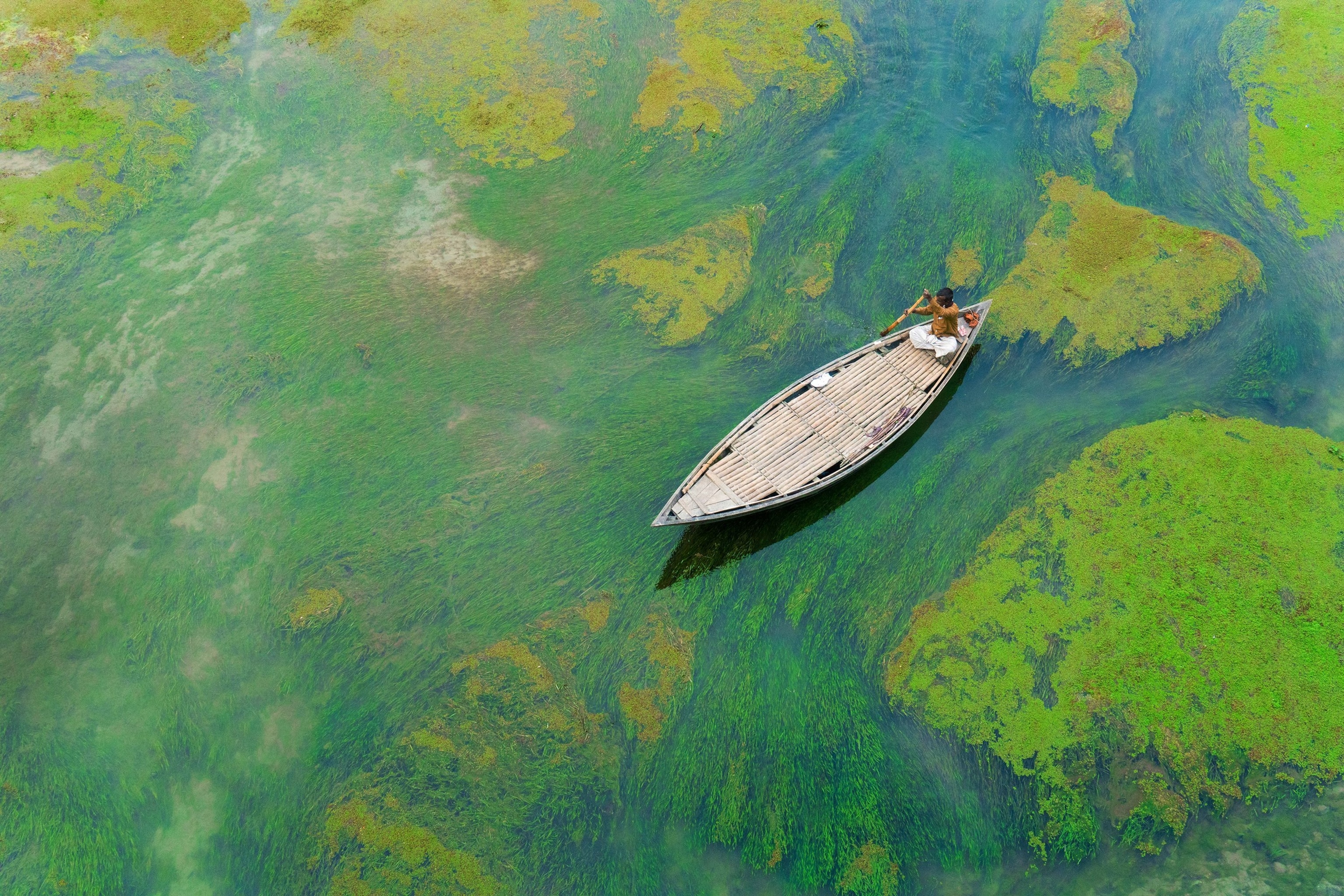 a boat crossing the Baral River in Bangladesh