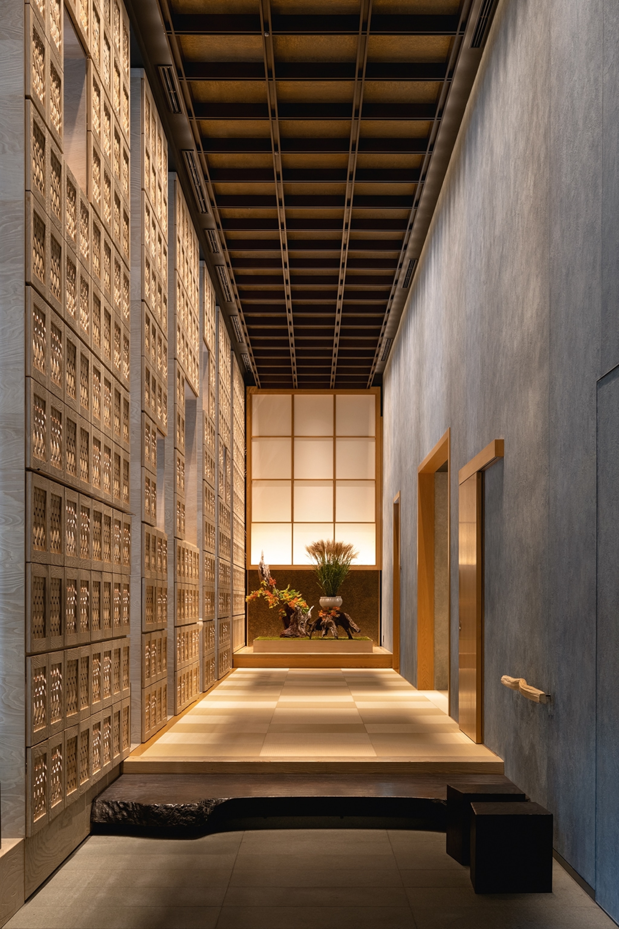 Low-lit lobby with shoji screen doors in Hoshinoya, Tokyo.