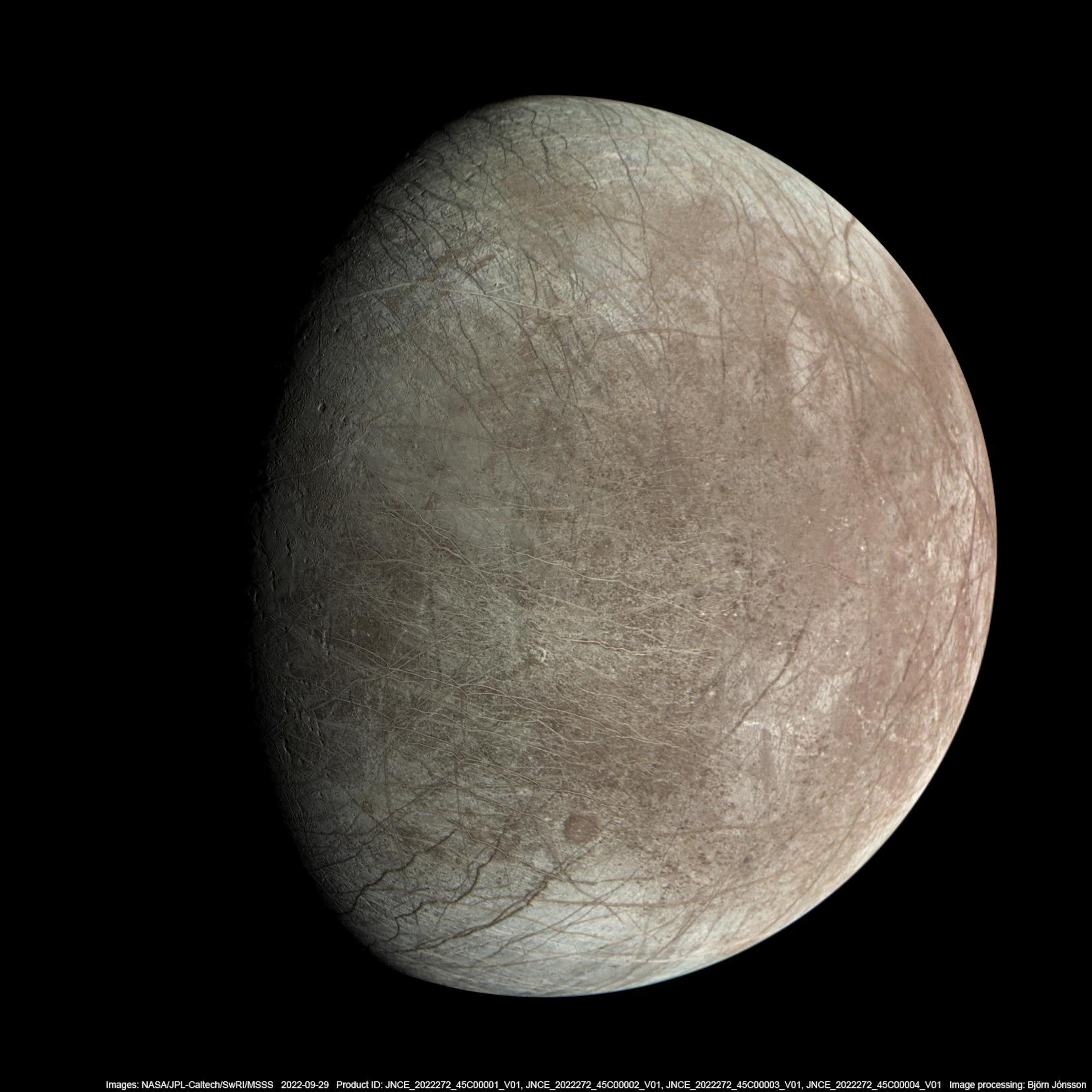 A high-resolution and detailed view of Europa's surface which is covered in criss-crossing ridges, fractures, and bands.