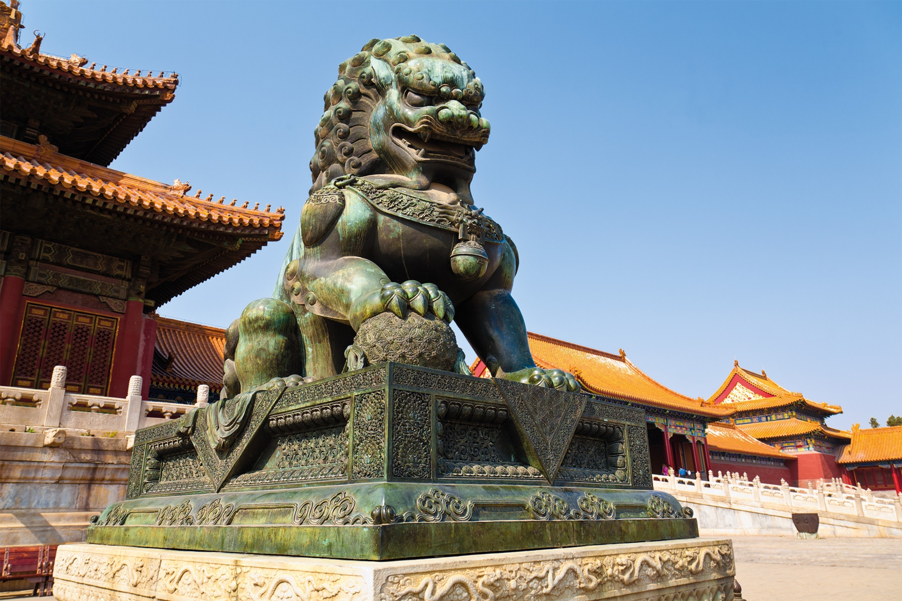 A bronze lion stands on each side of the pavilion stairs on the Golden River’s north bank.