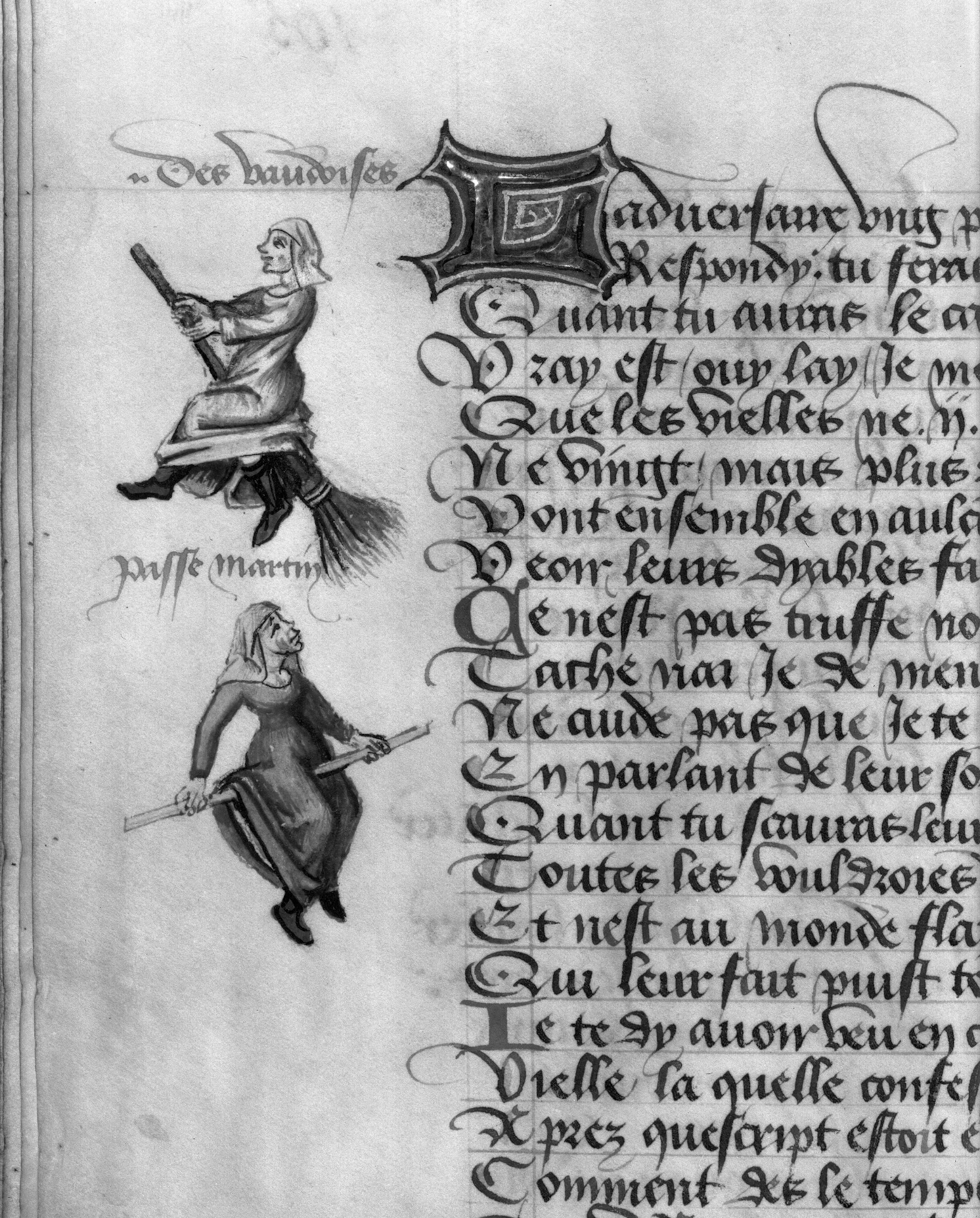 A picture of an open book. There are two witches drawn on the side of the page. Only some text is visible, it is written in French.