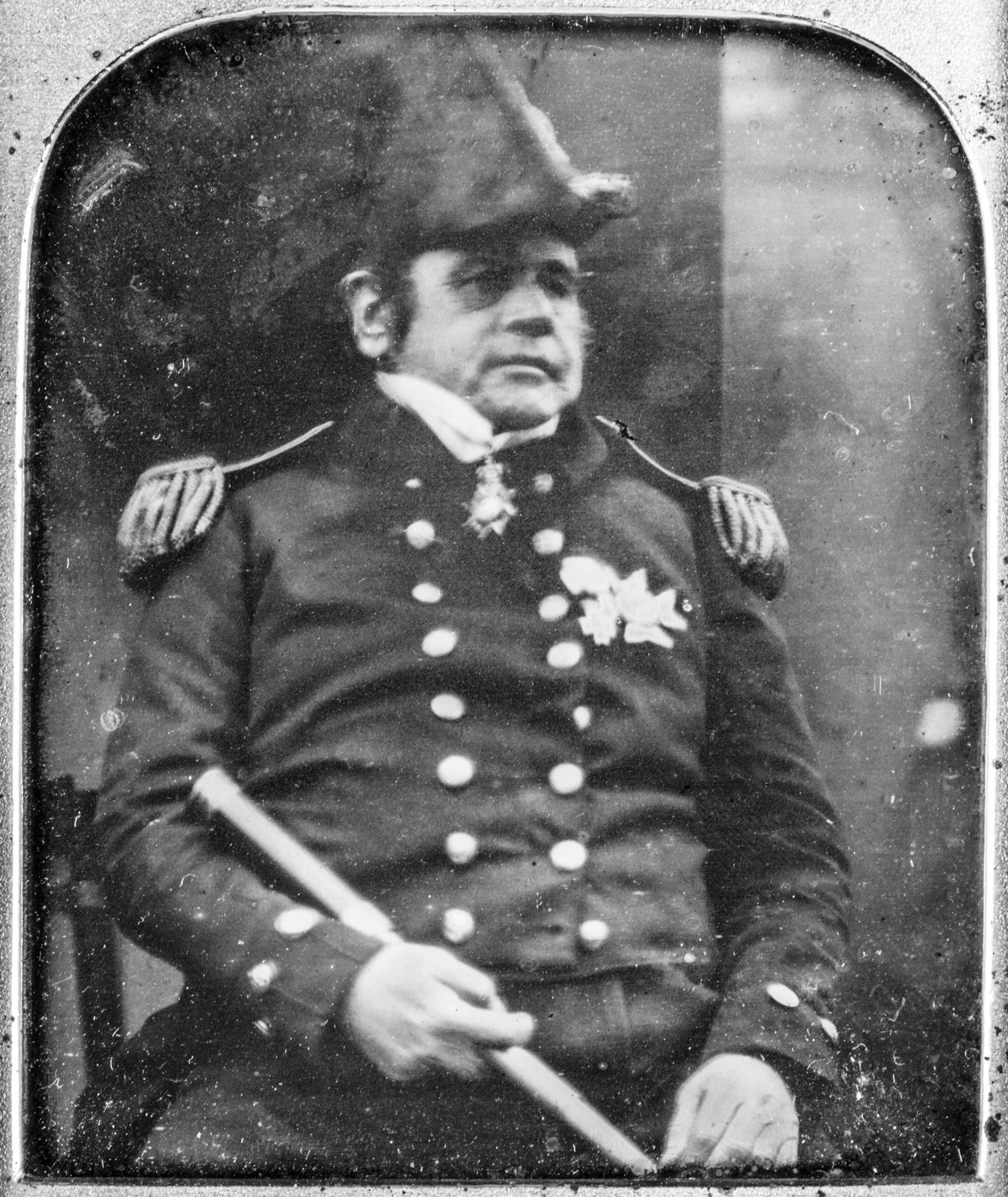 Black&White photo print of a man in marine officer coat and hat.