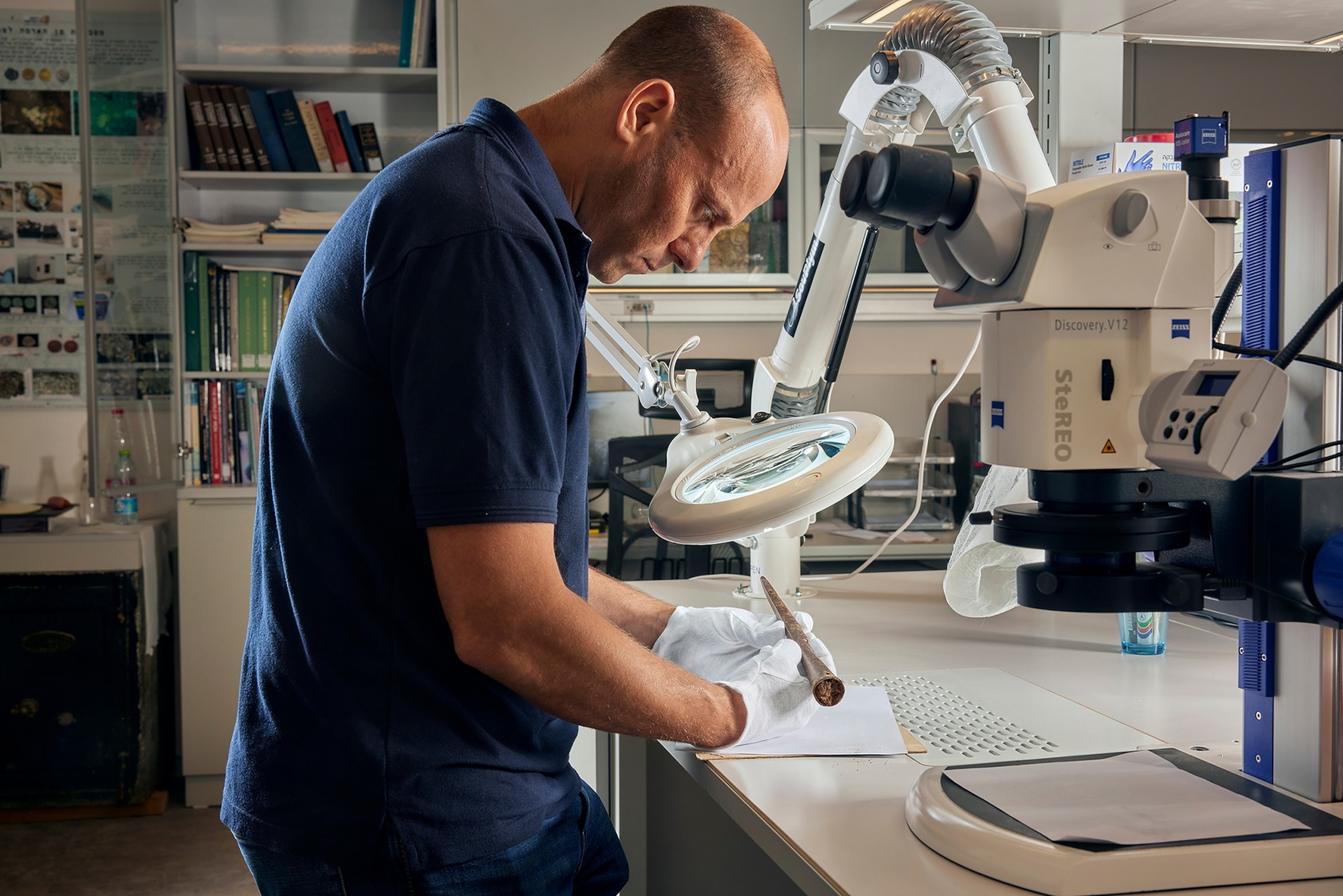 Eitan Klein examines the iron pilum (javelin) head in a research lab.