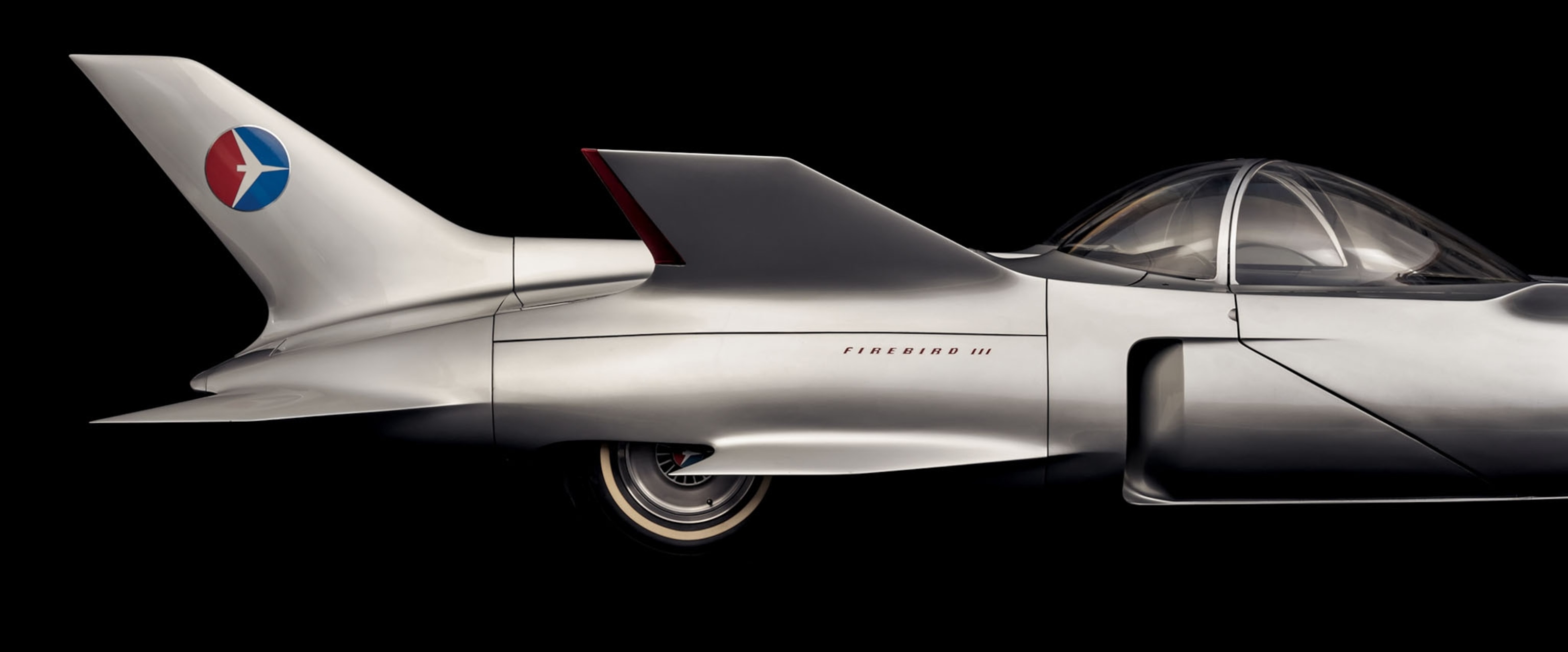 a sleek silver car on a black background