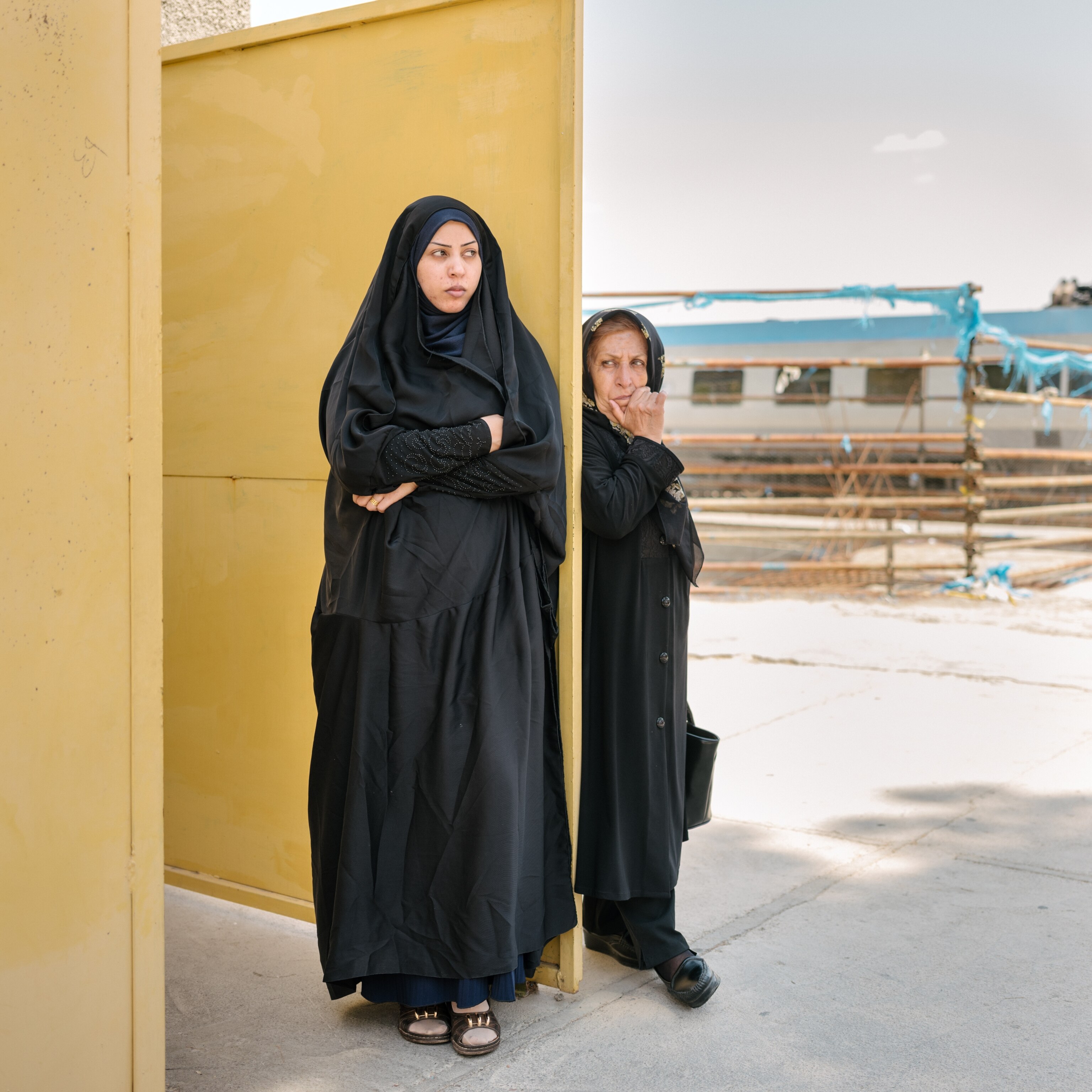 Women rest in the women's section during a prayer break