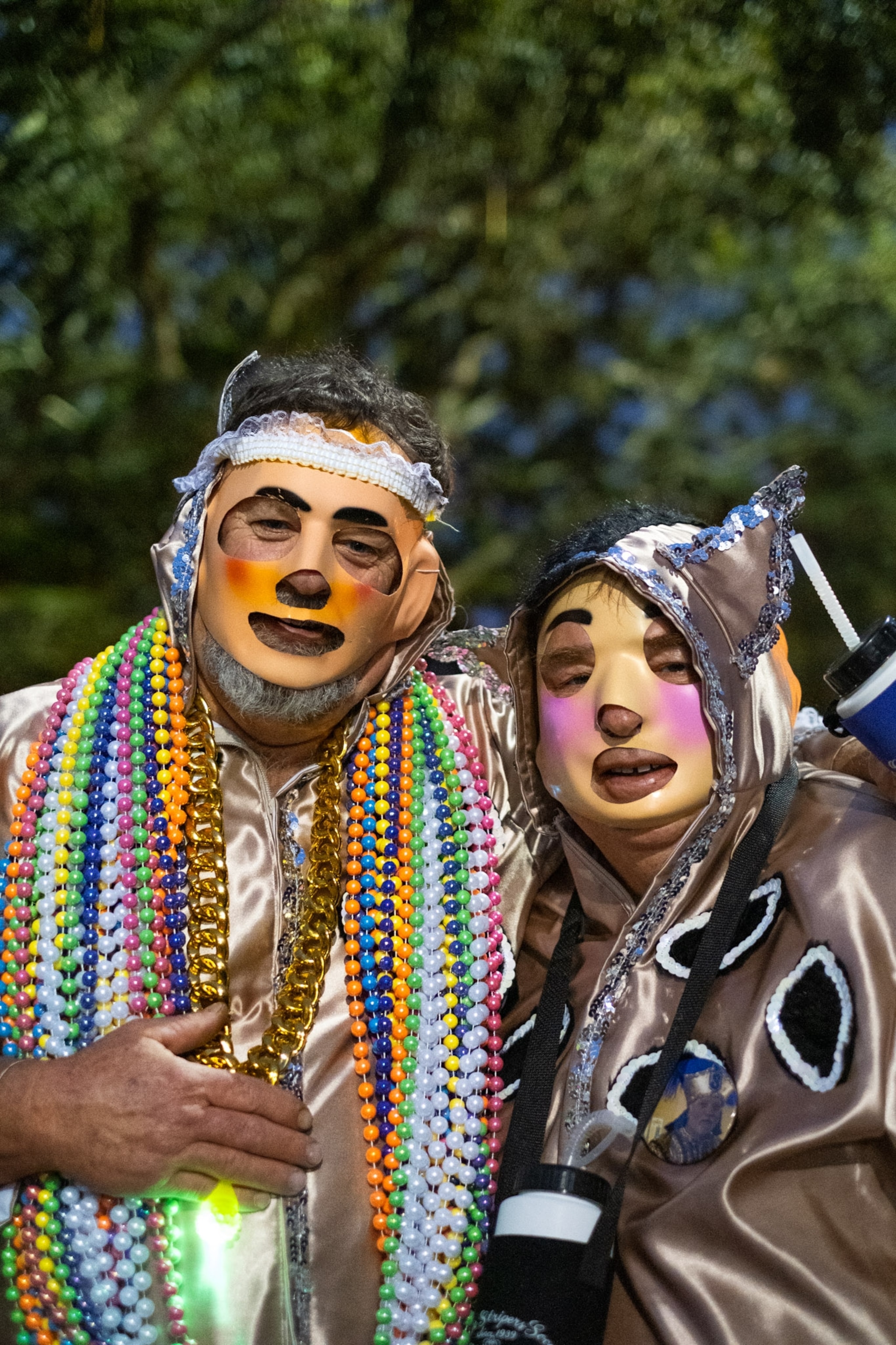 two people standing side by side wearing masks