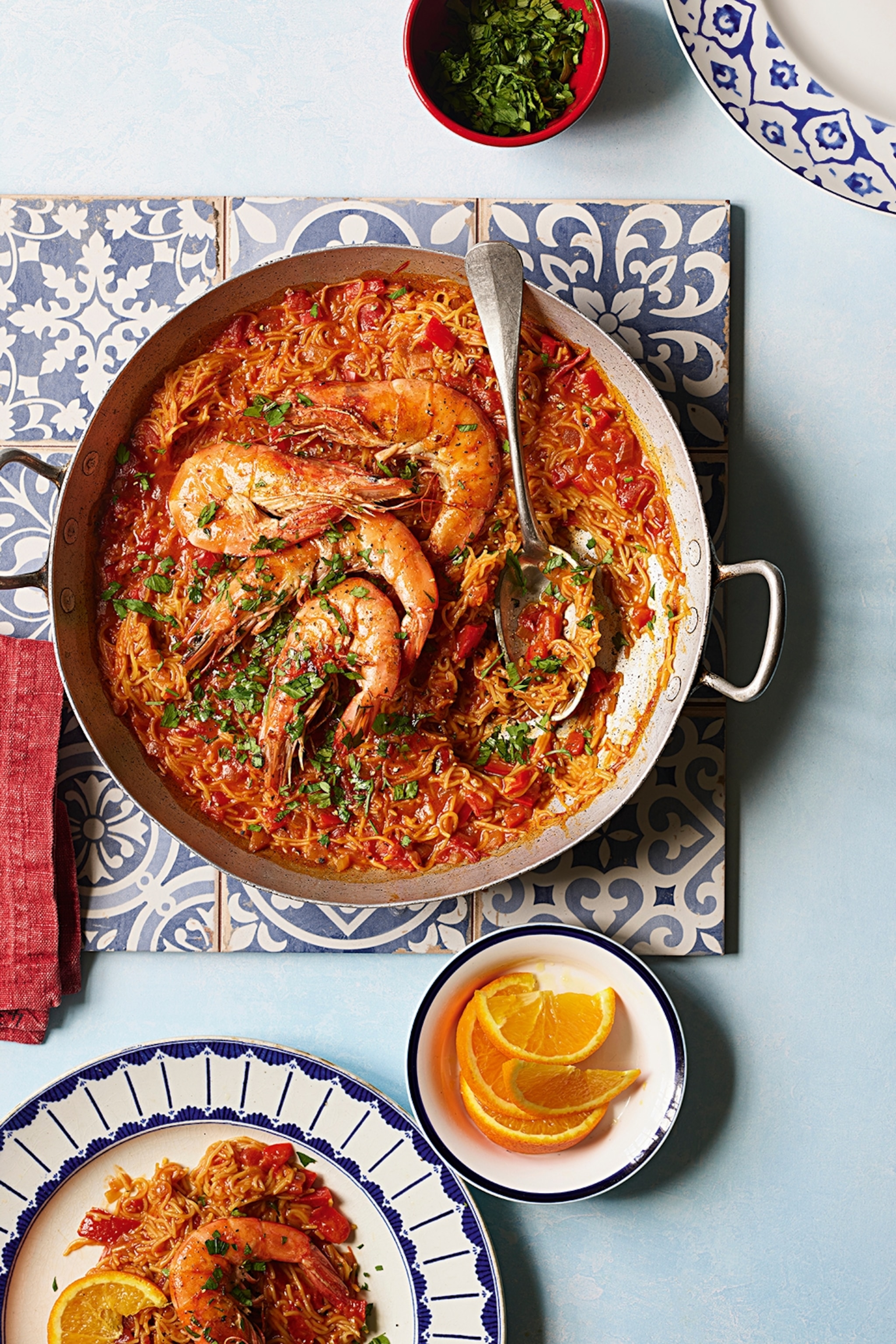 Paella dish filled with prawns and noodles