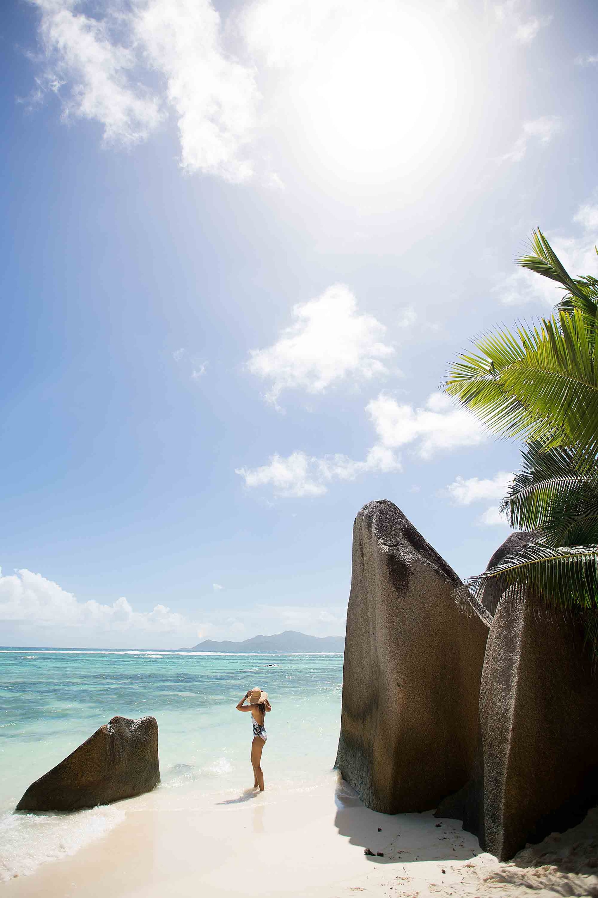 woman on Anse Source d'Argent beach in La Digue, Seychelles