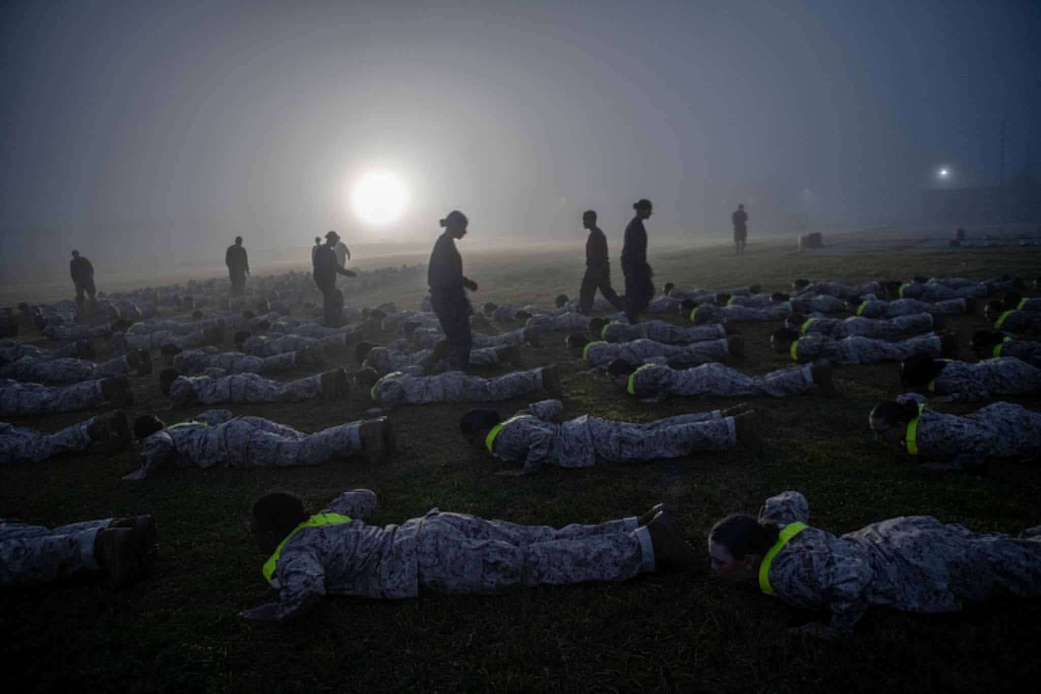 many people crawling along the floor during sunrise