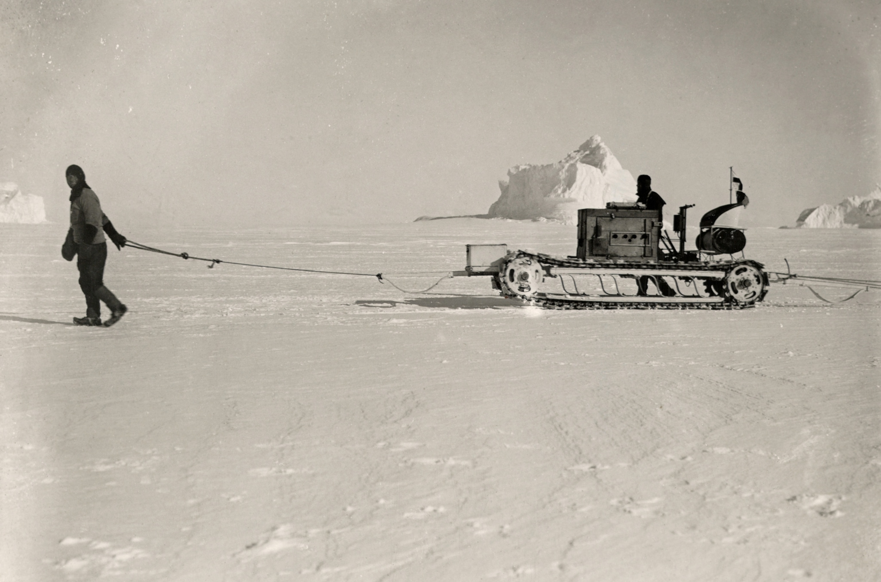 two expedition members with a motorized sledge