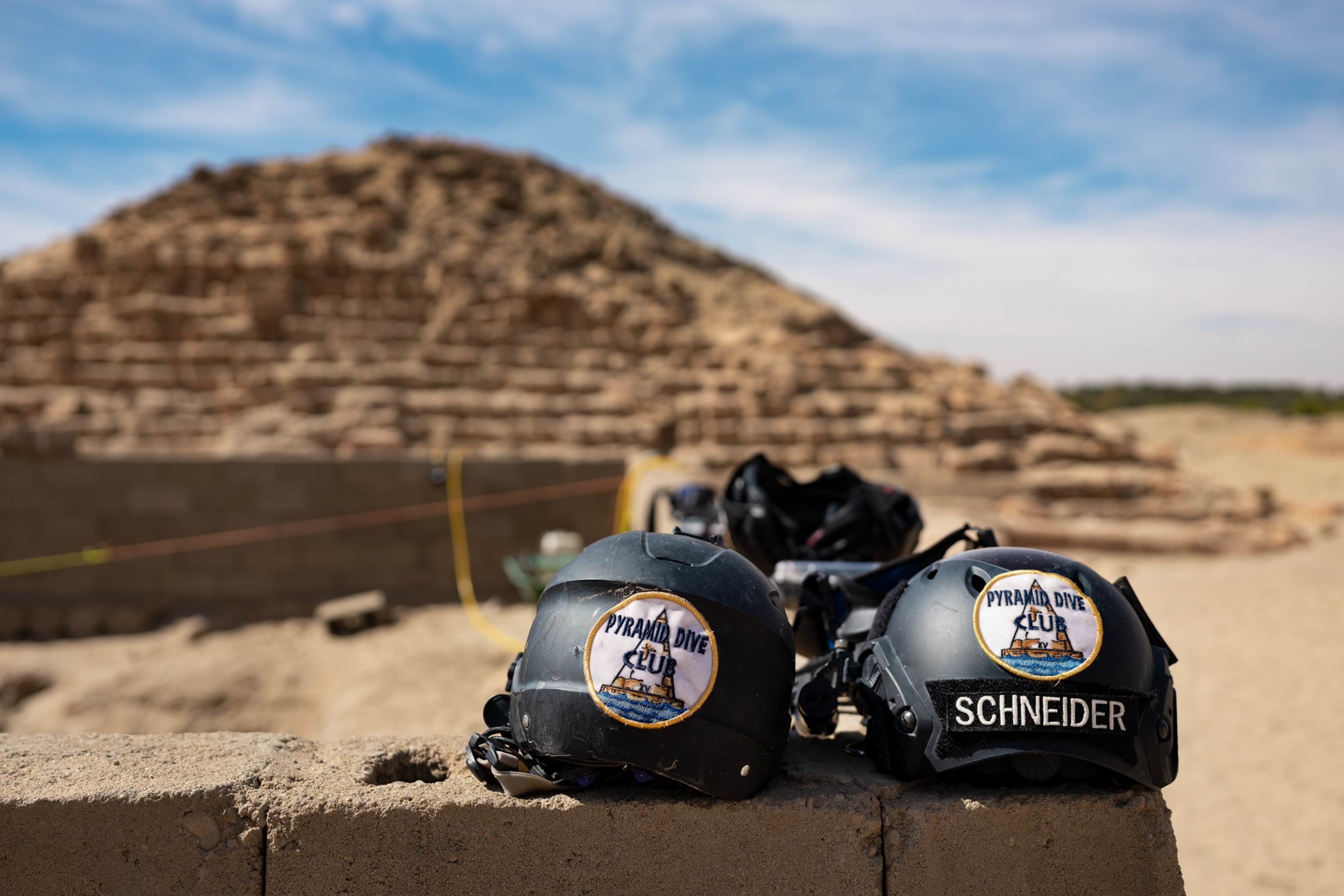 Picture of of two helmets and pyramids on the background