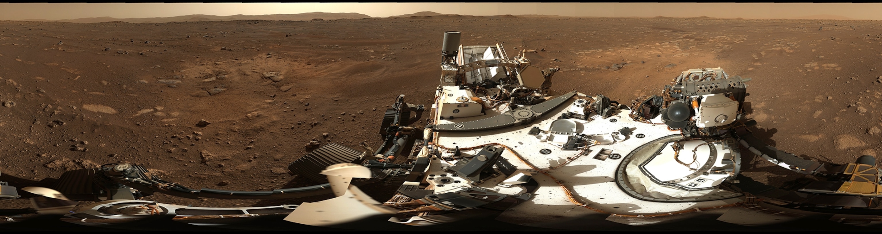 Picture of rover's selfie with rock and sediment on background.