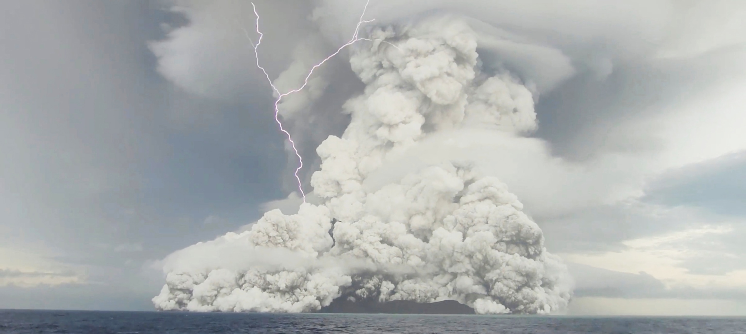 An eruption occurs at the underwater volcano Hunga Tonga-Hunga Ha'apai off Tonga, January 14, 2022 in this screen grab obtained from a social media video. Video recorded January 14, 2022.
