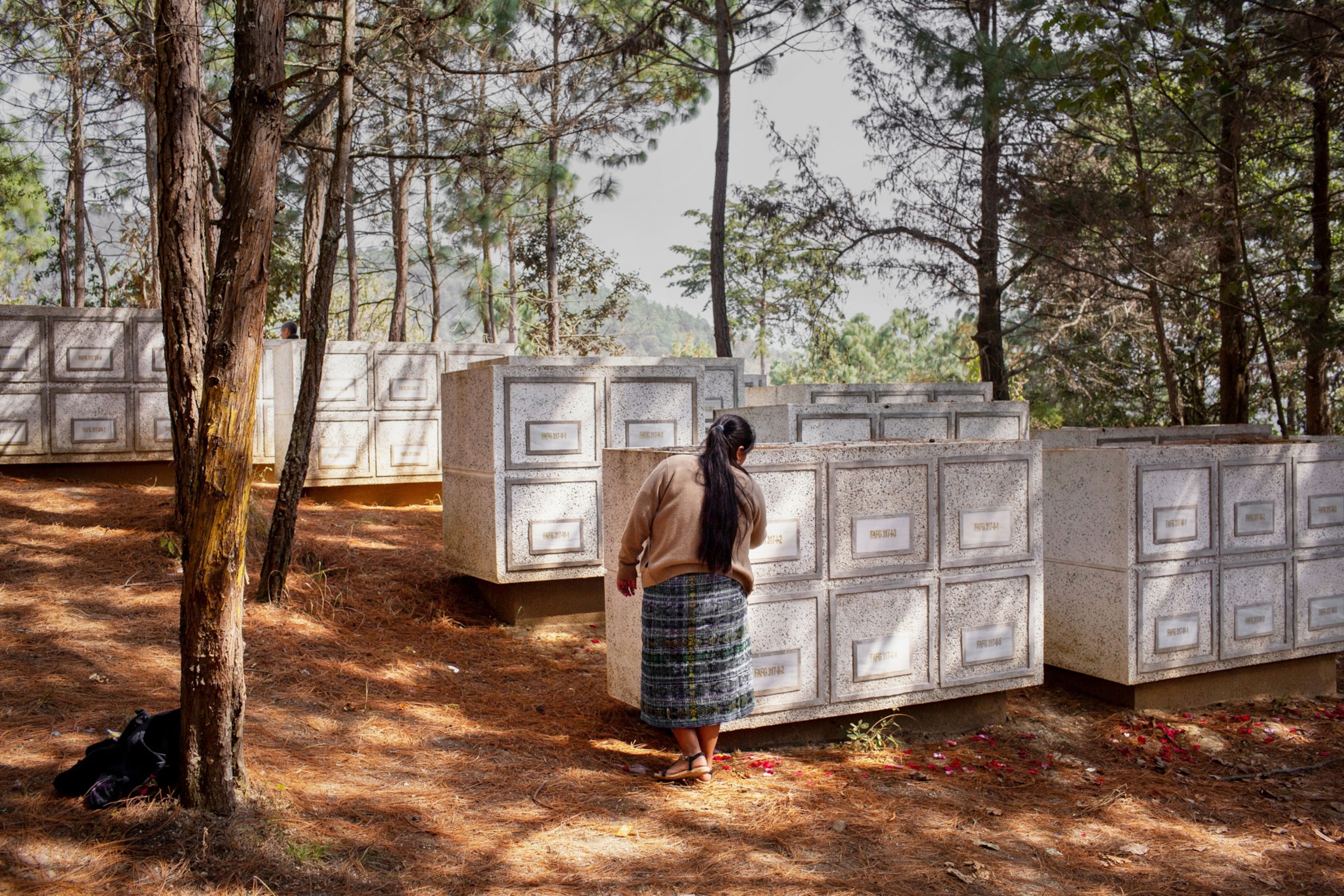 a woman at a memorial site in Guatemala