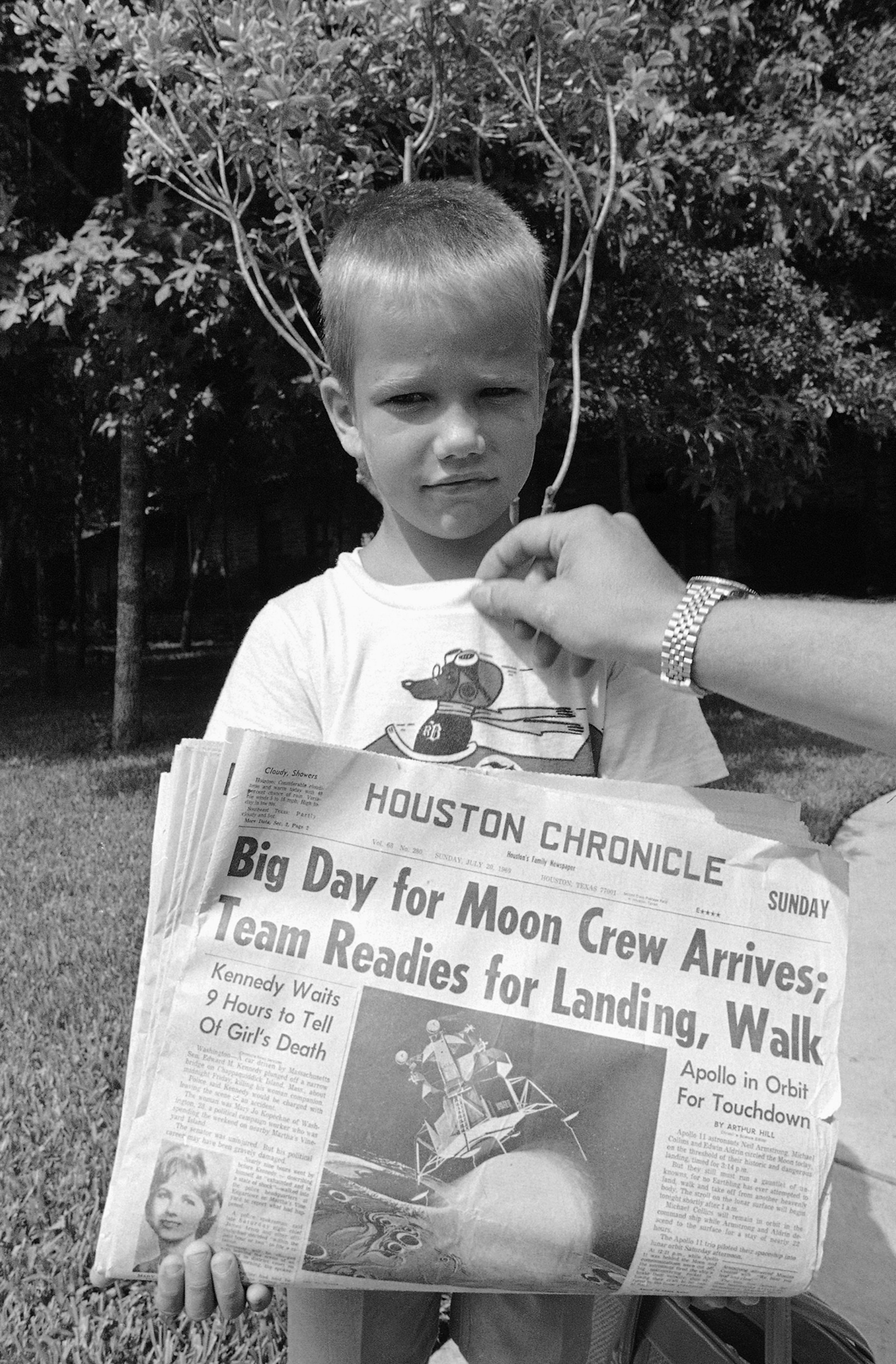 a boy holding a newspaper