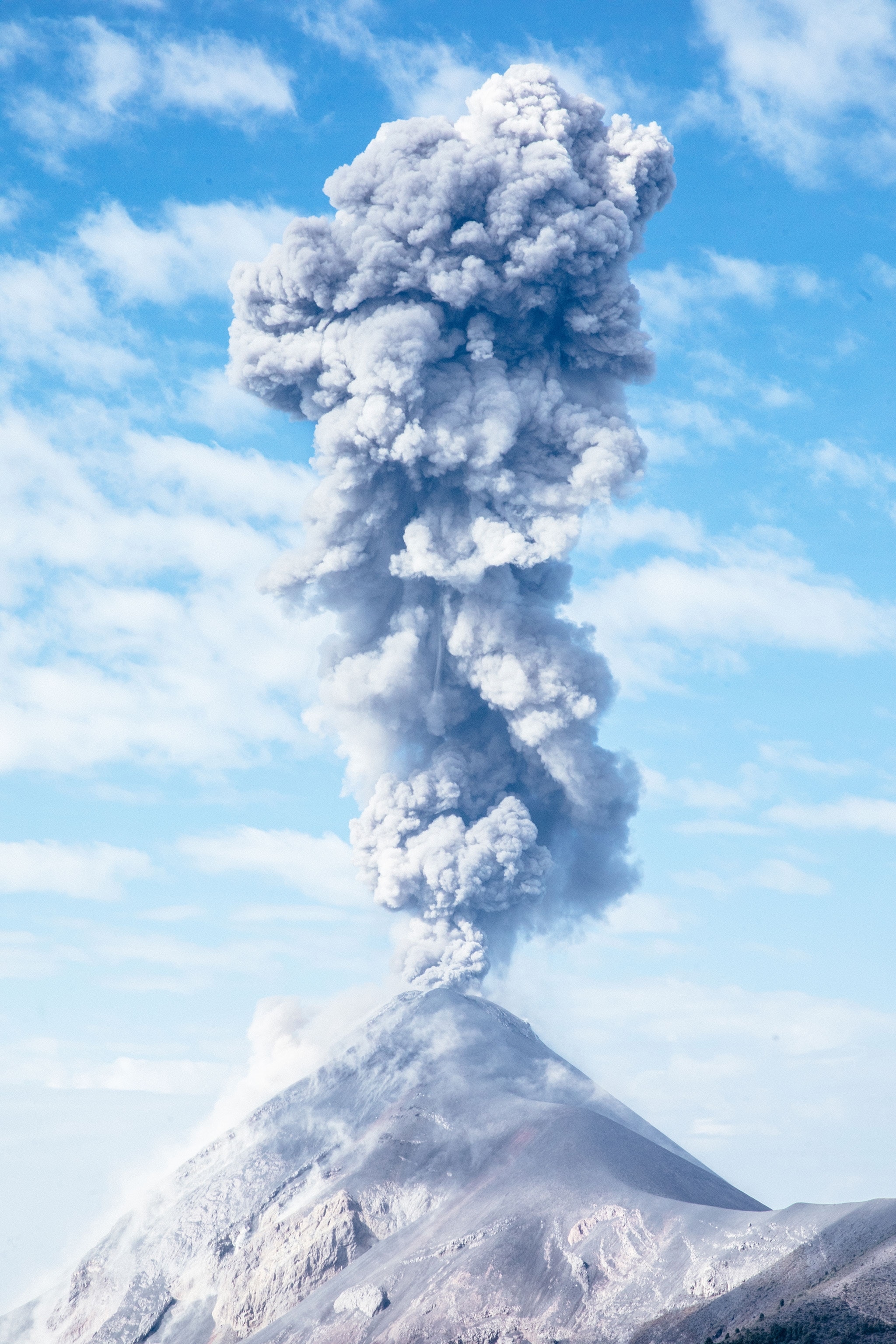 A plume of smoke ascends from a large eruption of Volcán de Fuego