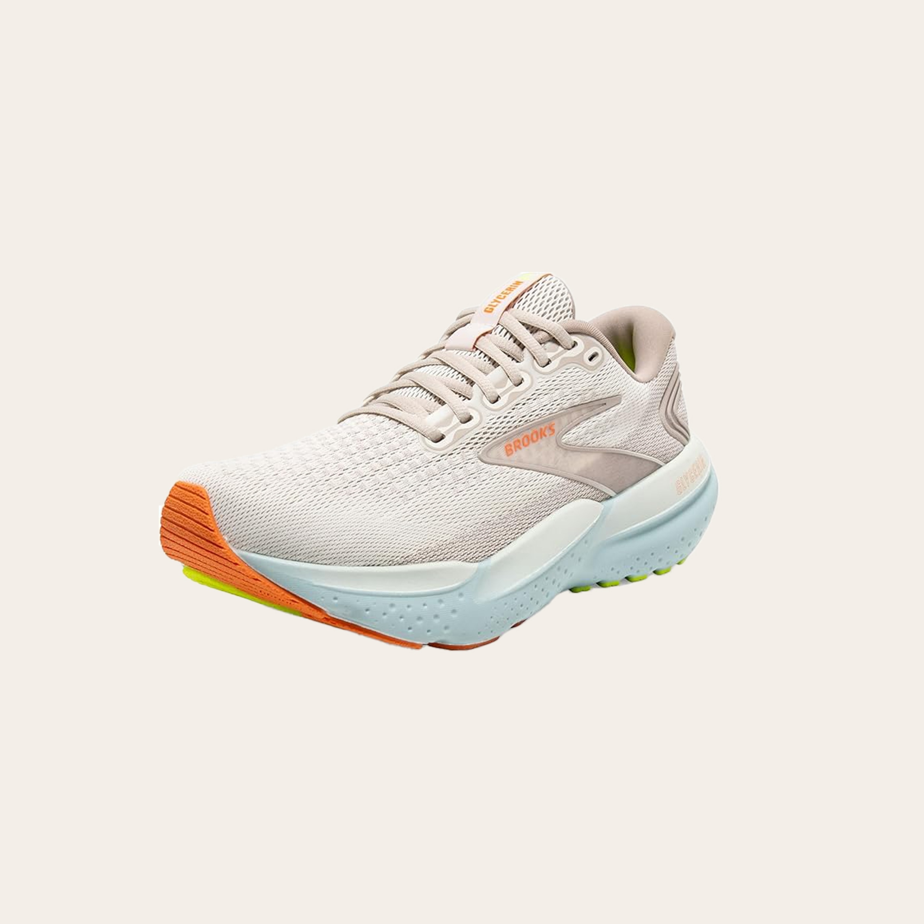 An image of tan sneakers with orange accents.