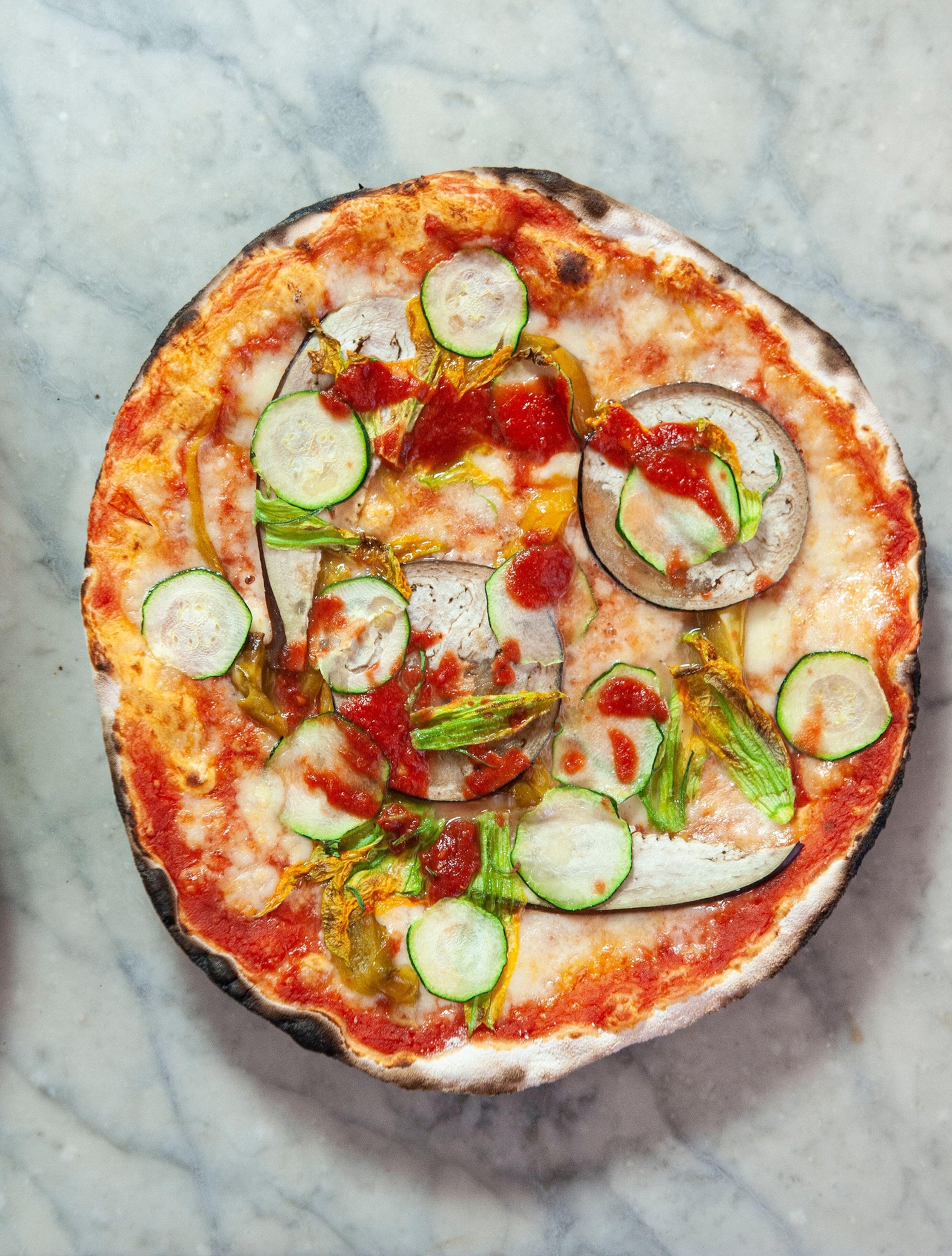 Ortolana pizza or vegetable garden pizza, on marble benchtop, at Pizzeria ai Marmi, Trastevere district of Rome, Italy