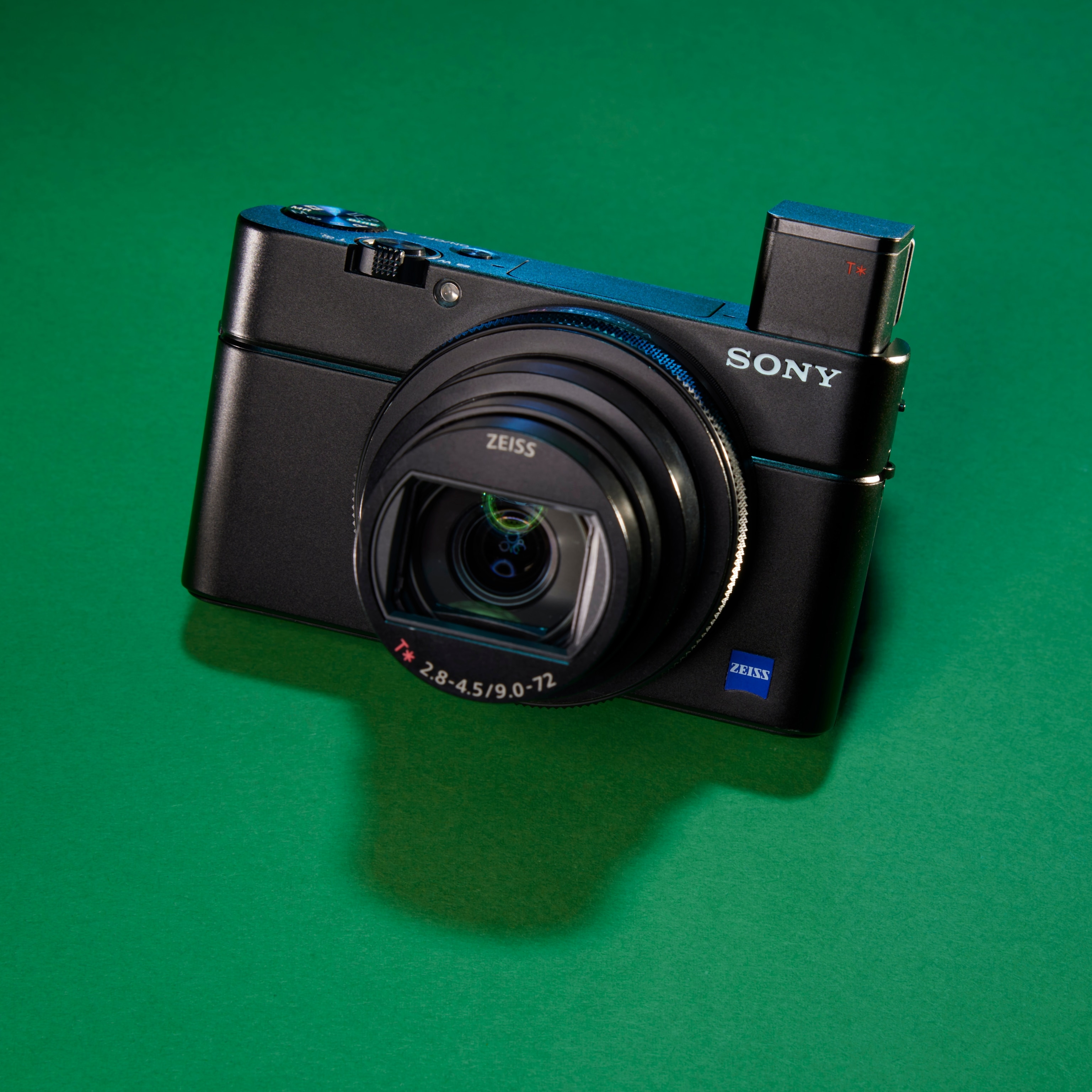 Studio photograph of the Sony RX100VII camera against a green background