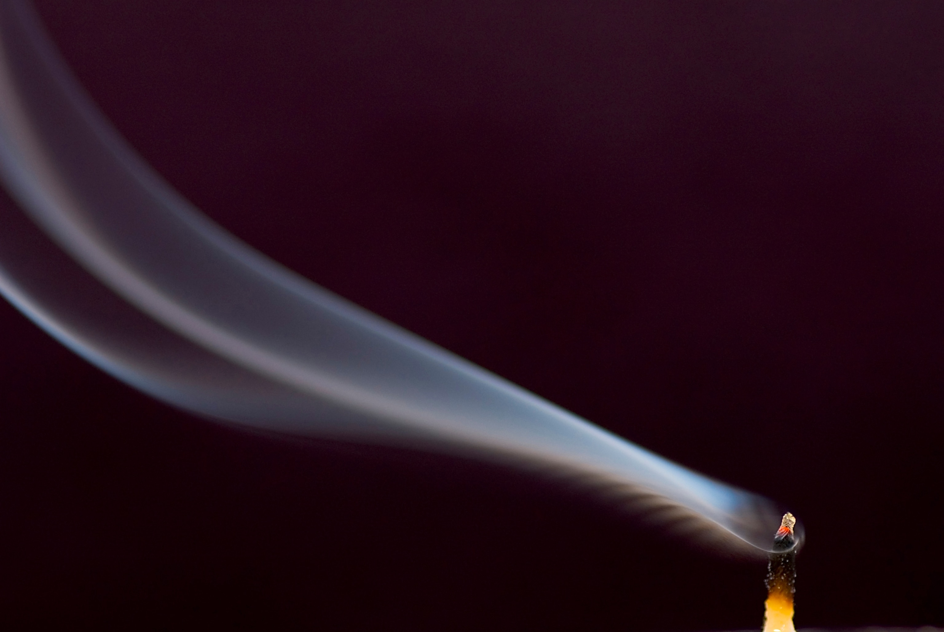 smoke blows from an extinguished tea light