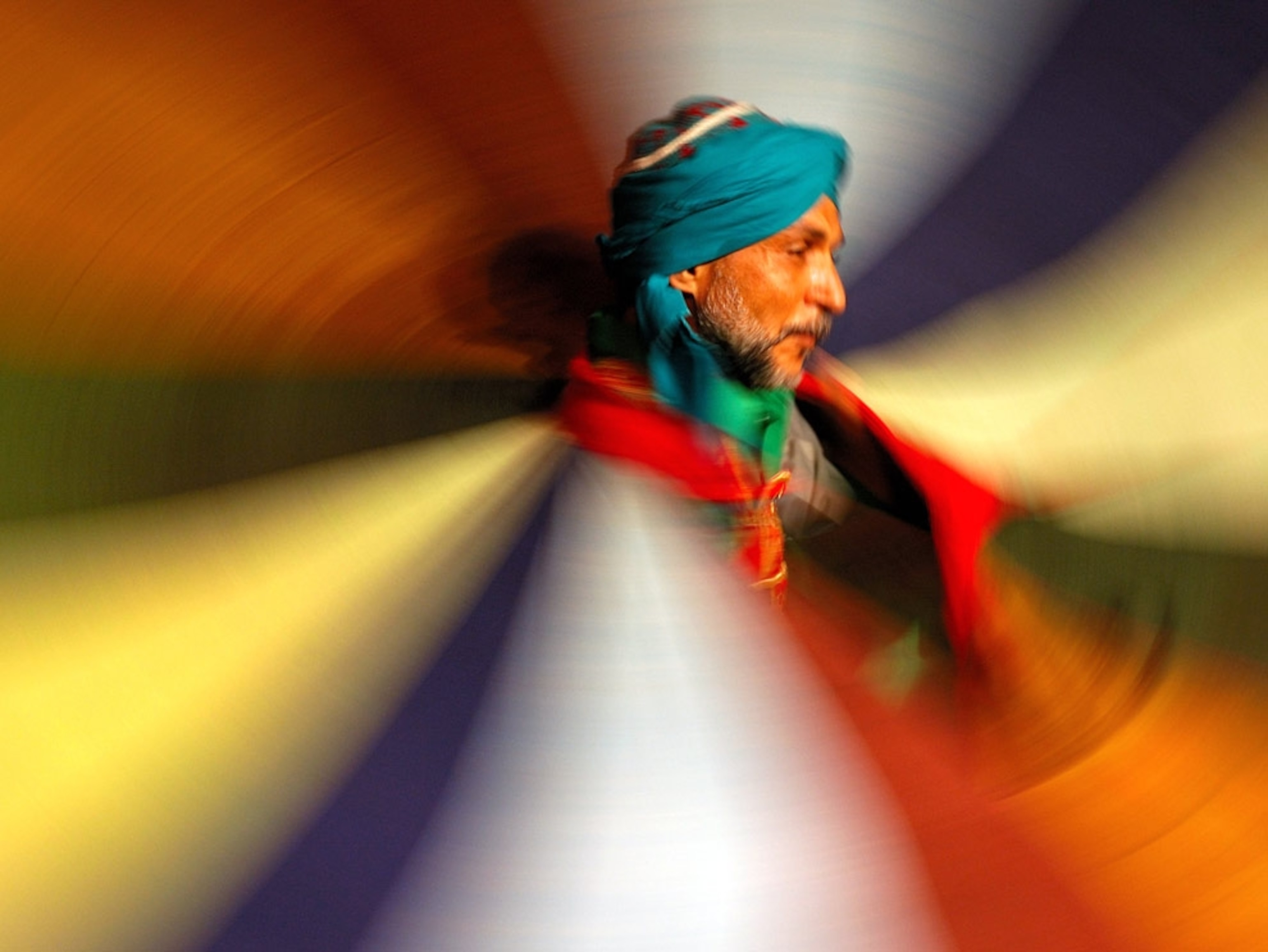 A man dancing in colorful dress
