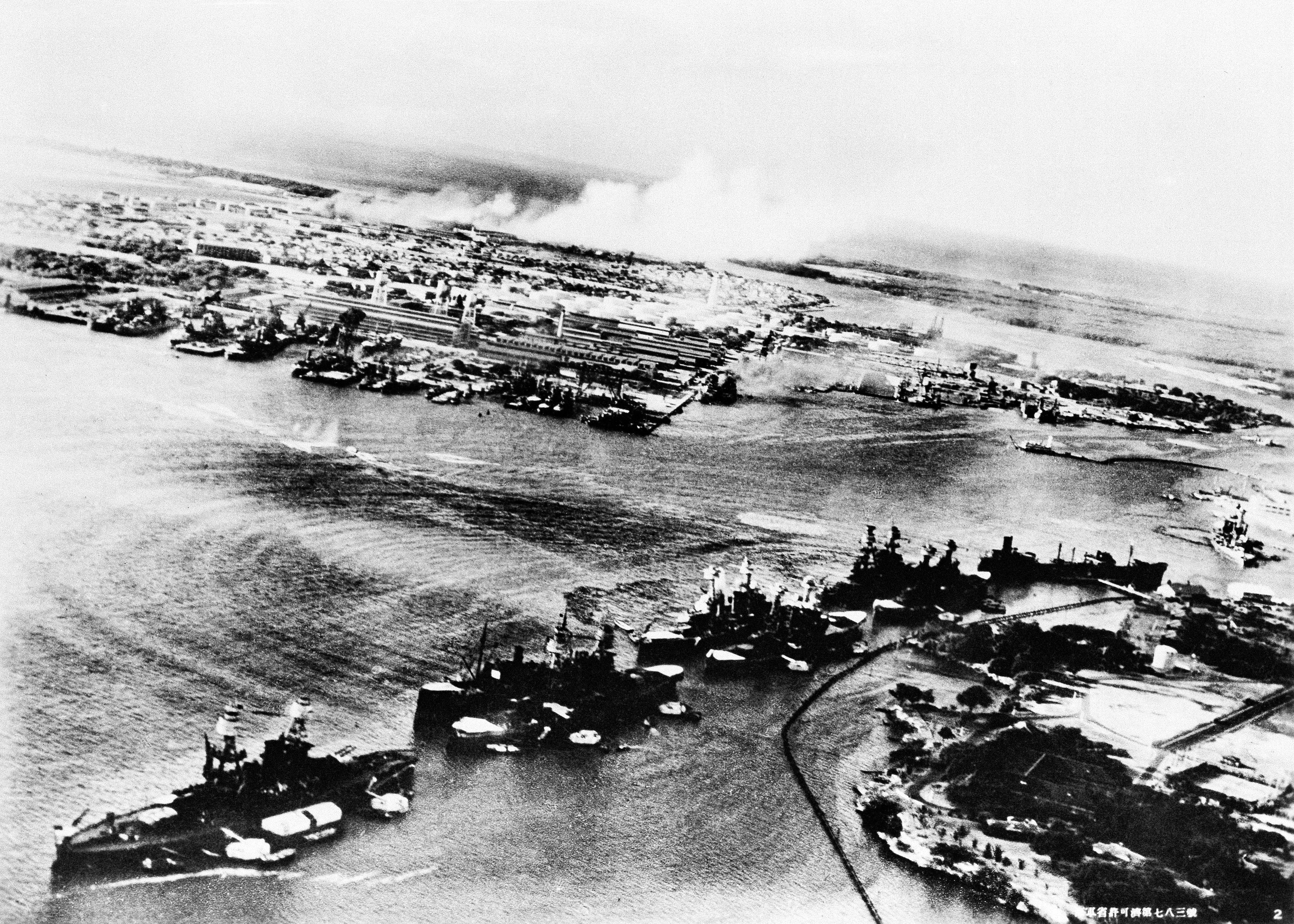 An aerial view of battleships lines up at Pearl Harbor.