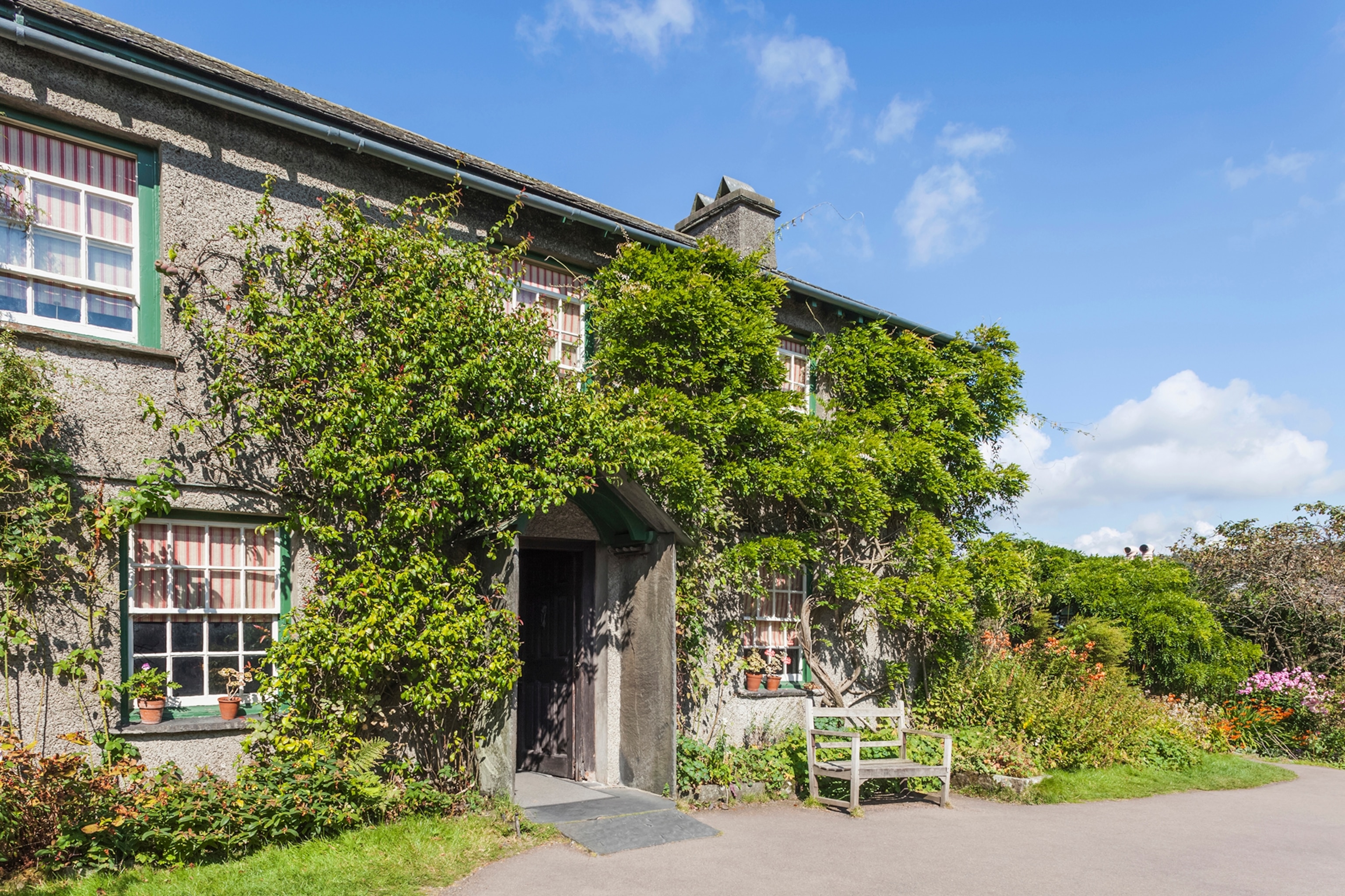 Wisteria-clad cottage with blue sky in the background